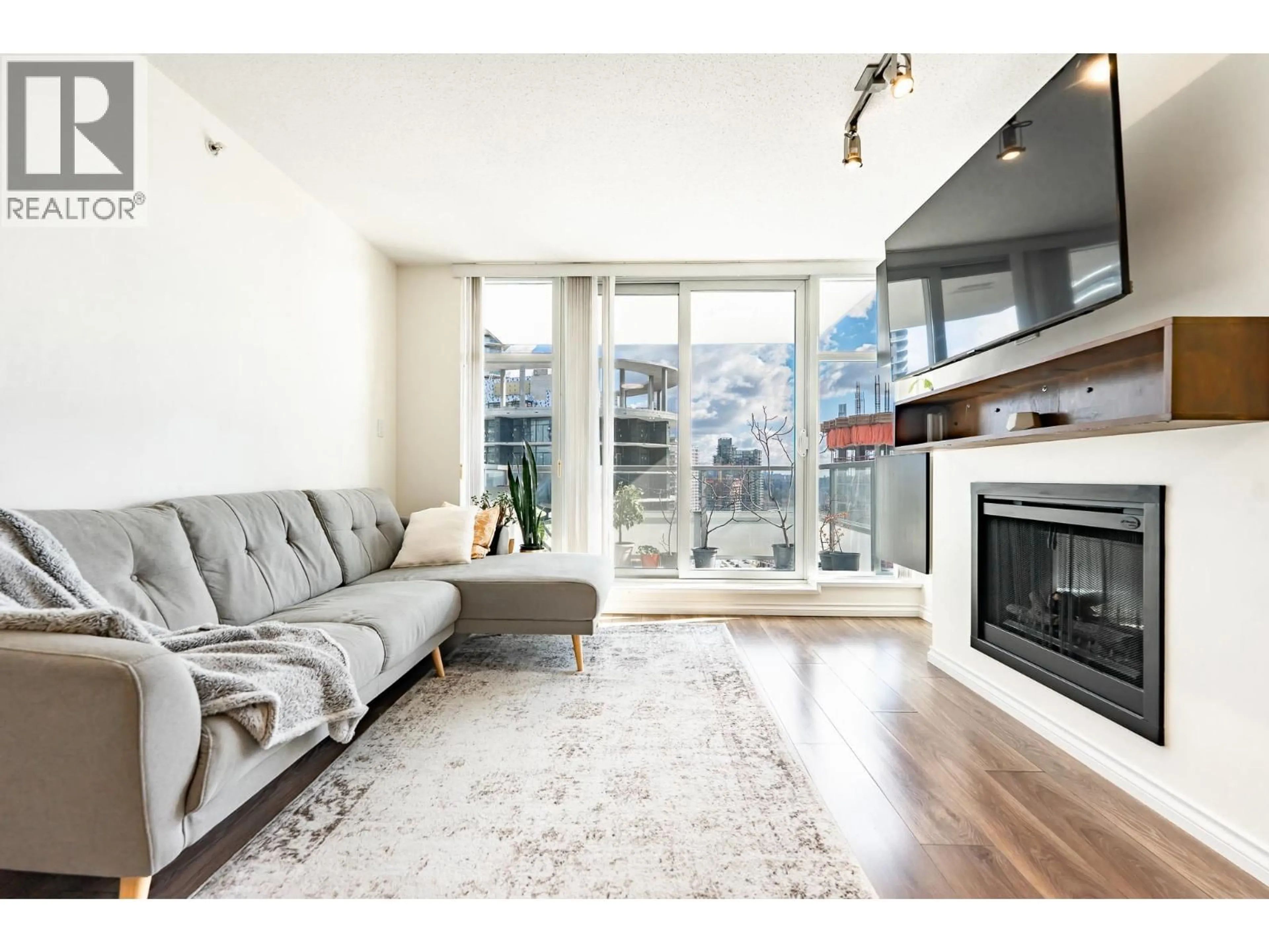 Living room with furniture, wood/laminate floor for 2703 - 2289 YUKON CRESCENT, Burnaby British Columbia V5C0B2