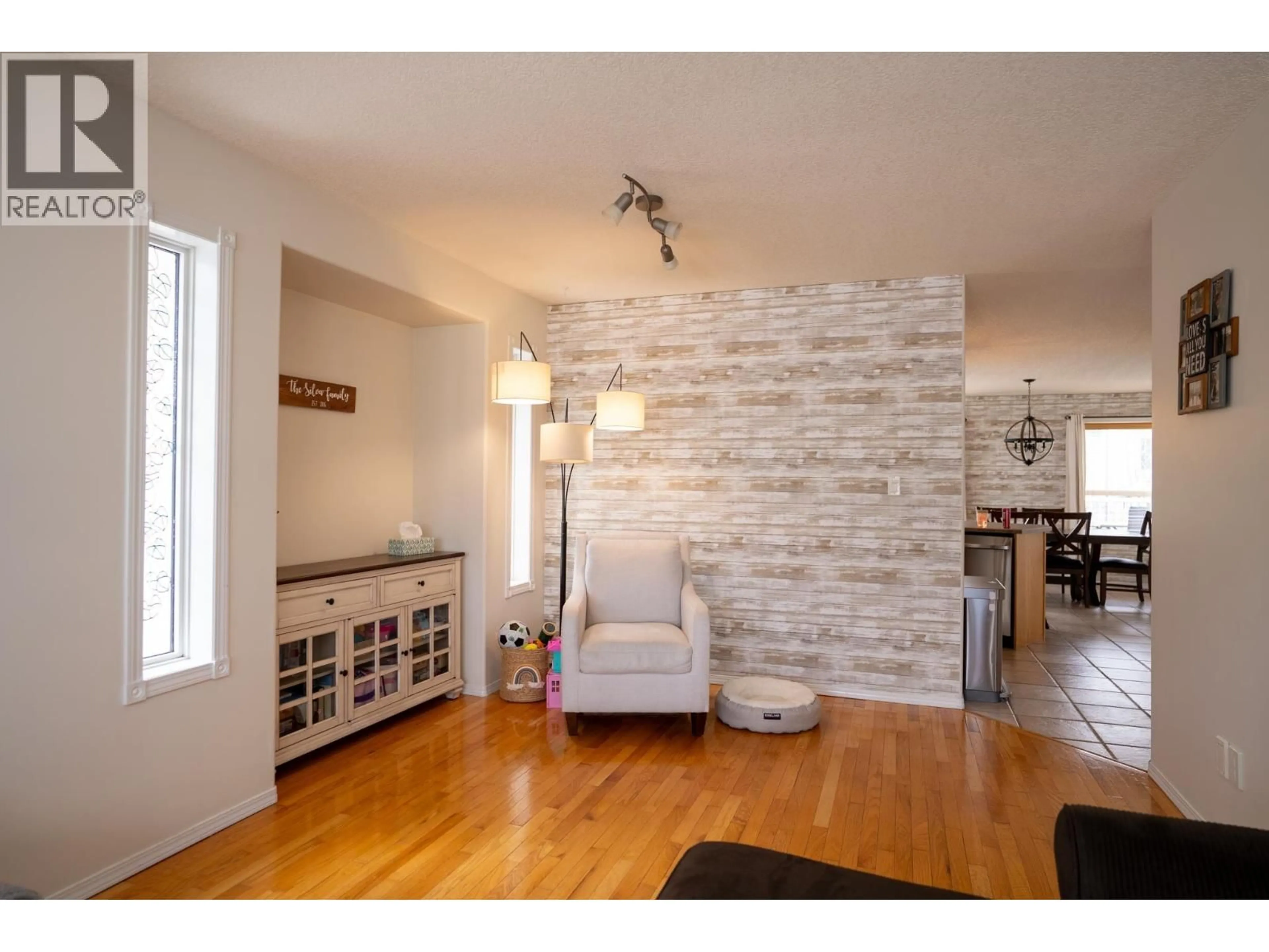 Living room with furniture, wood/laminate floor for 6965 WESTGATE AVENUE, Prince George British Columbia V2N5R3