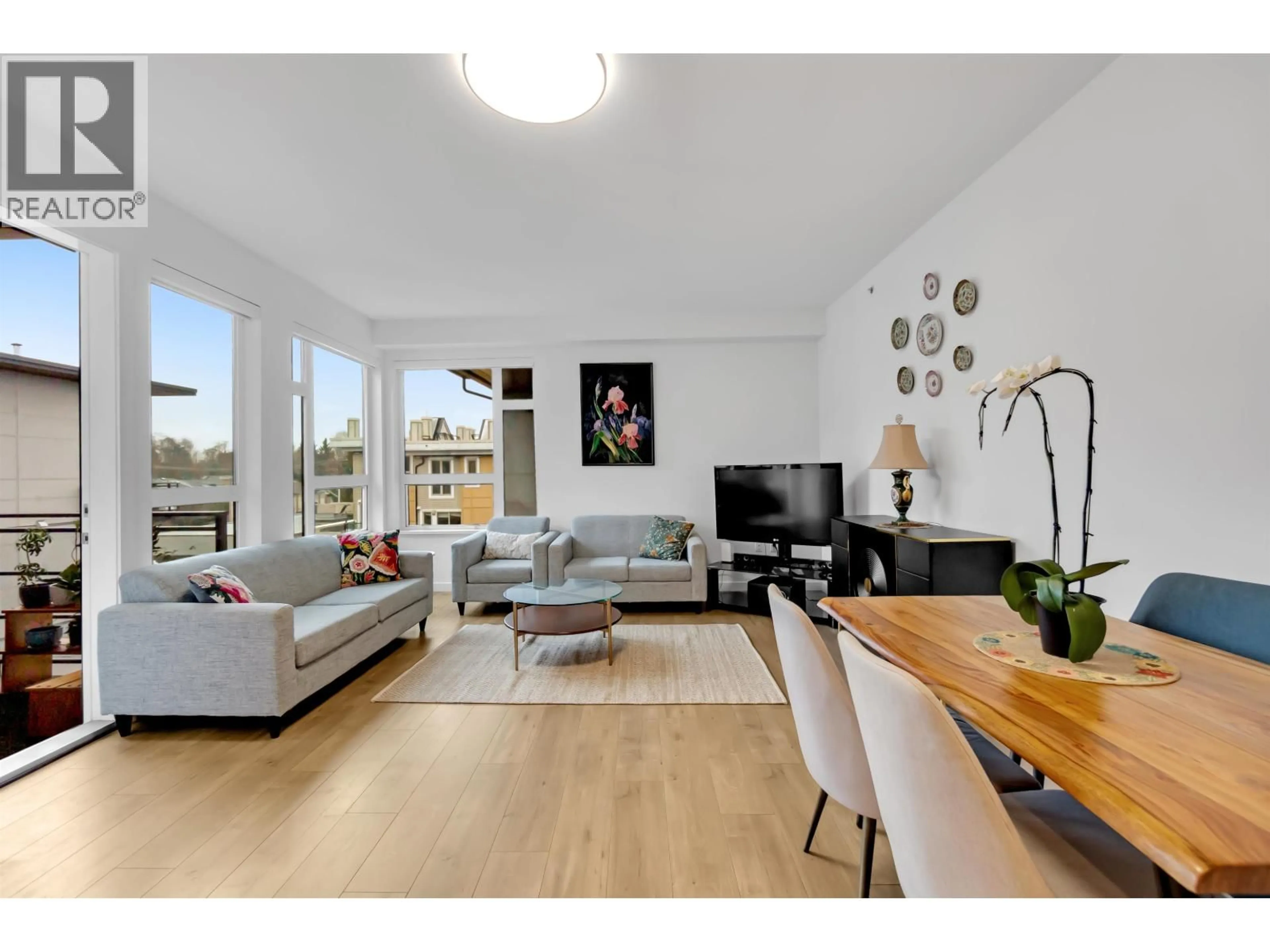 Living room with furniture, wood/laminate floor for 303 - 715 15 STREET, North Vancouver British Columbia V7M1T2