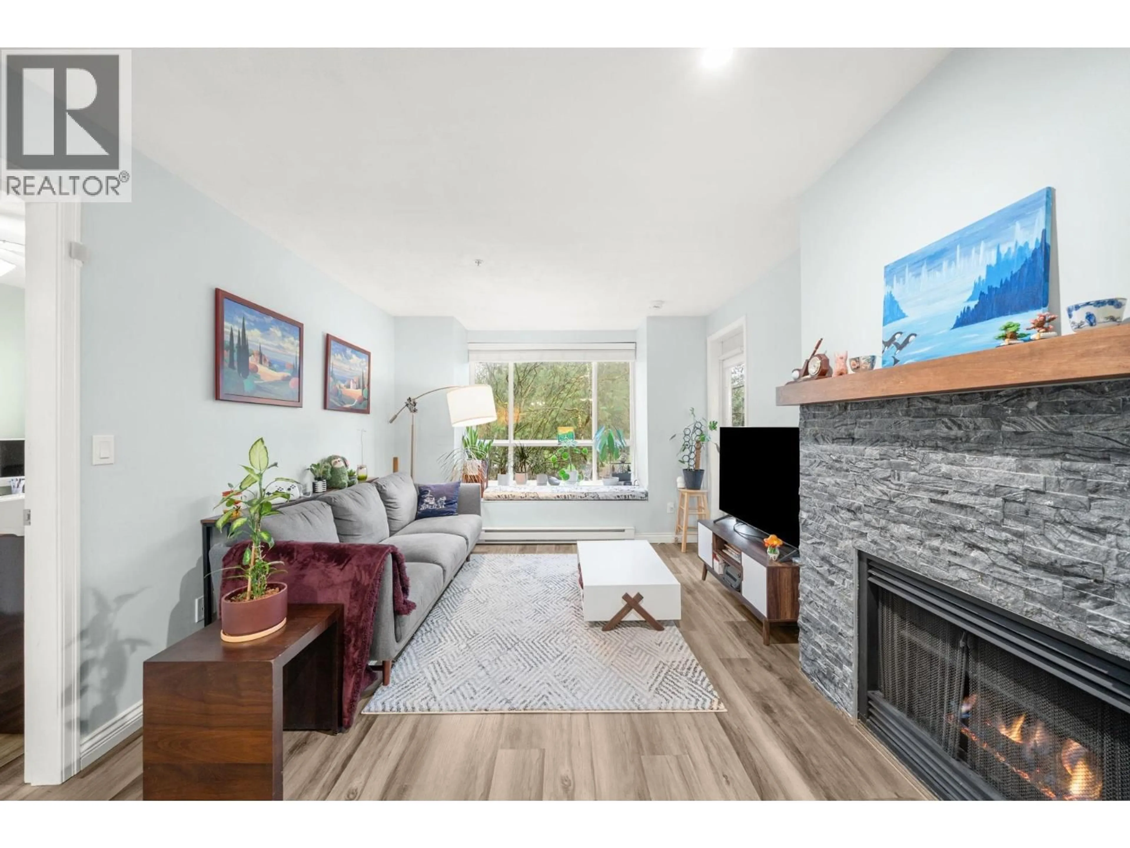 Living room with furniture, wood/laminate floor for 316 - 6833 VILLAGE, Burnaby British Columbia V5E4M1