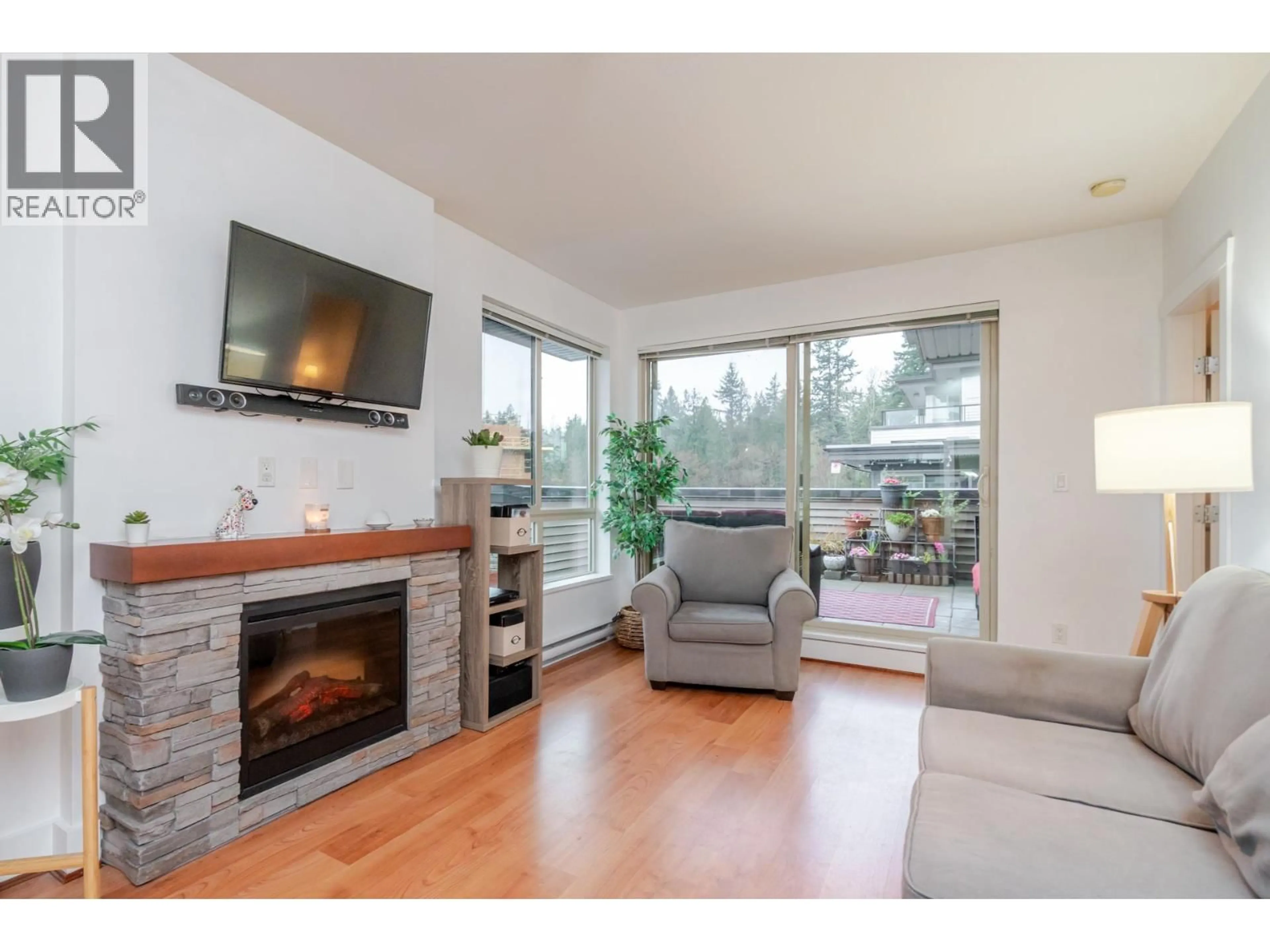 Living room with furniture, wood/laminate floor for 302 - 7428 BYRNEPARK WALK, Burnaby British Columbia V3N0B4