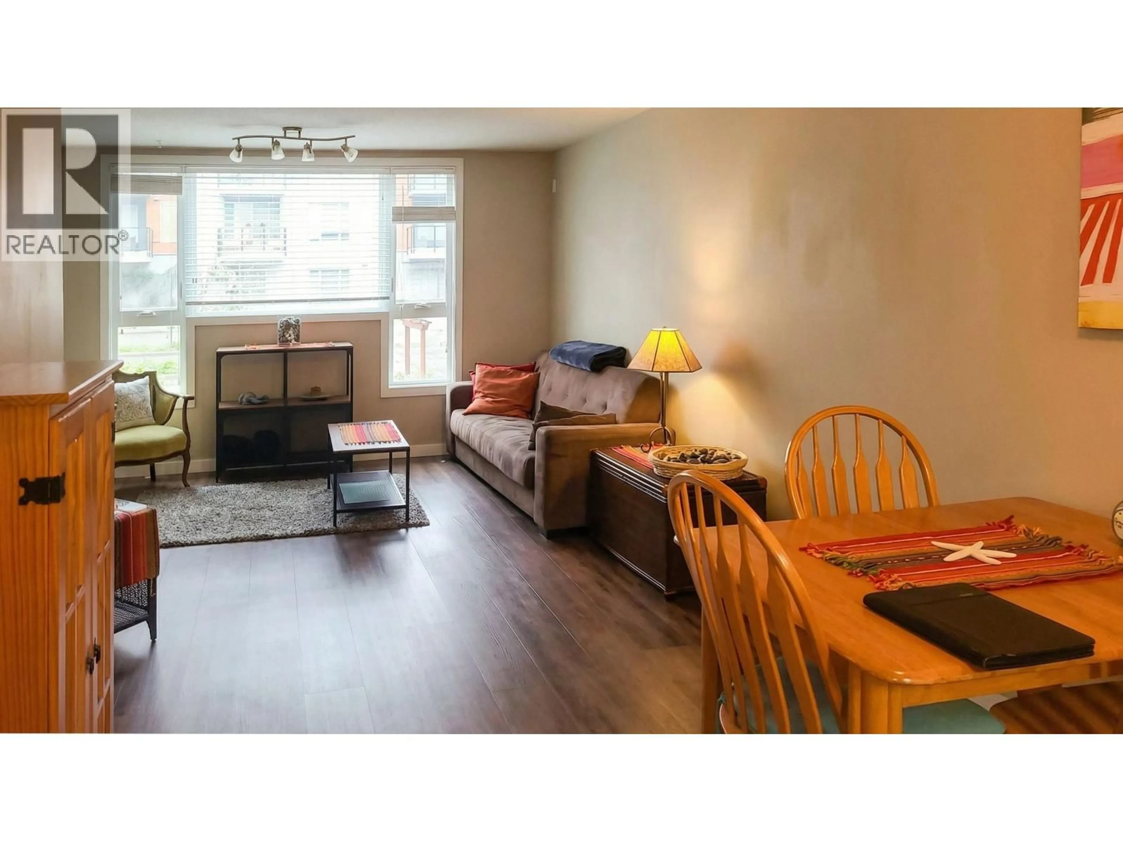 Living room with furniture, wood/laminate floor for 203 - 11595 FRASER STREET, Maple Ridge British Columbia V2X0X7