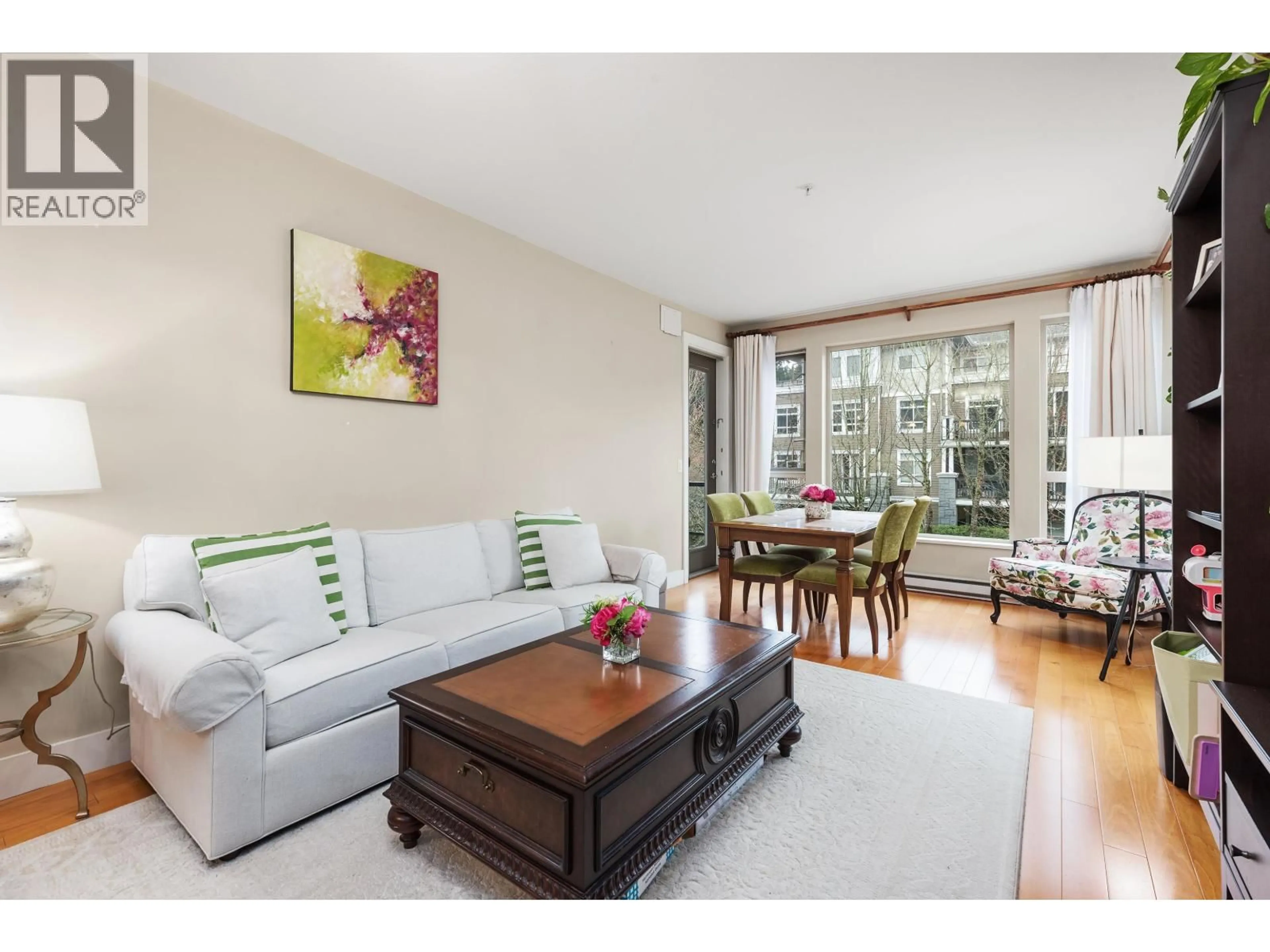 Living room with furniture, wood/laminate floor for 202 - 6268 EAGLES DRIVE, Vancouver British Columbia V6T0A2