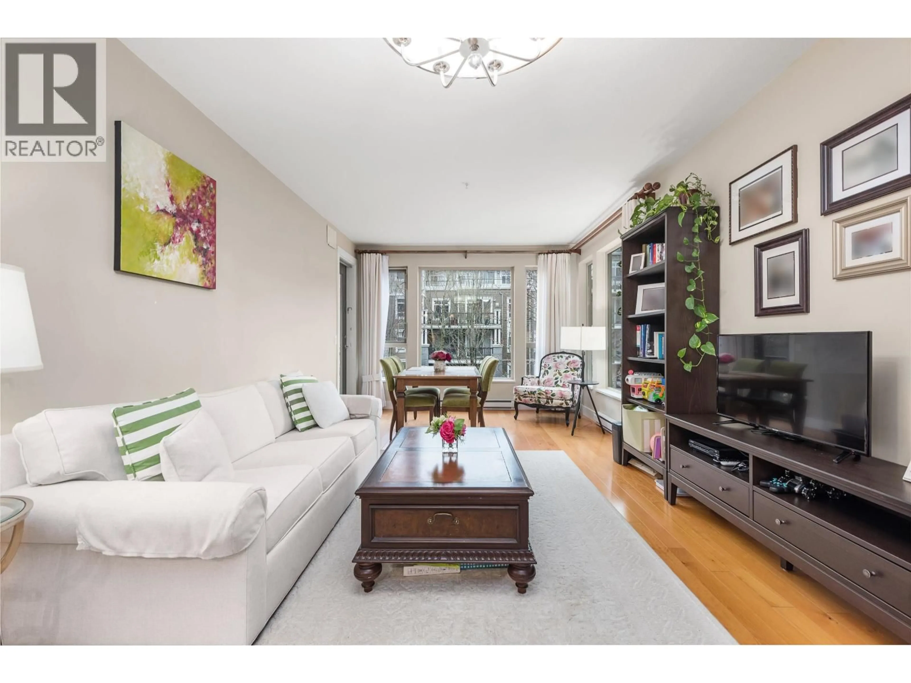 Living room with furniture, wood/laminate floor for 202 - 6268 EAGLES DRIVE, Vancouver British Columbia V6T0A2
