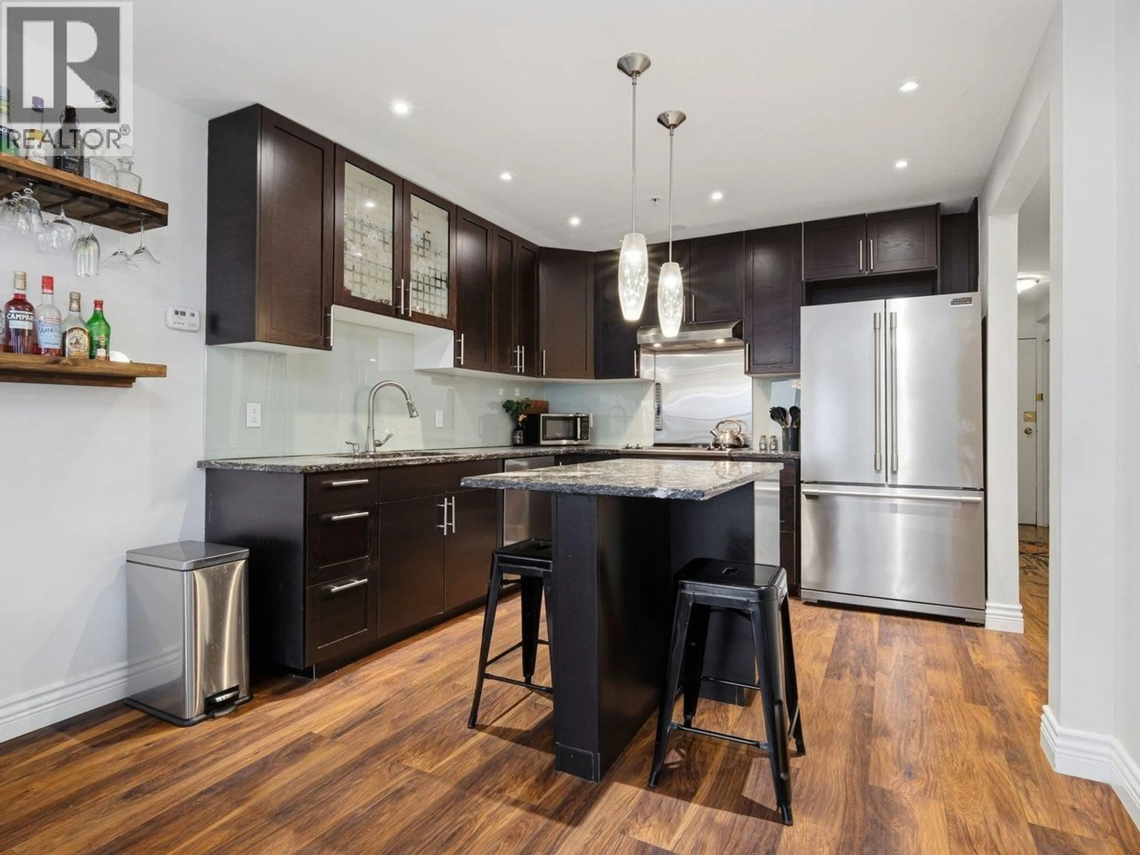 Open concept kitchen, wood/laminate floor for 216 - 1549 KITCHENER STREET, Vancouver British Columbia V5L2V8