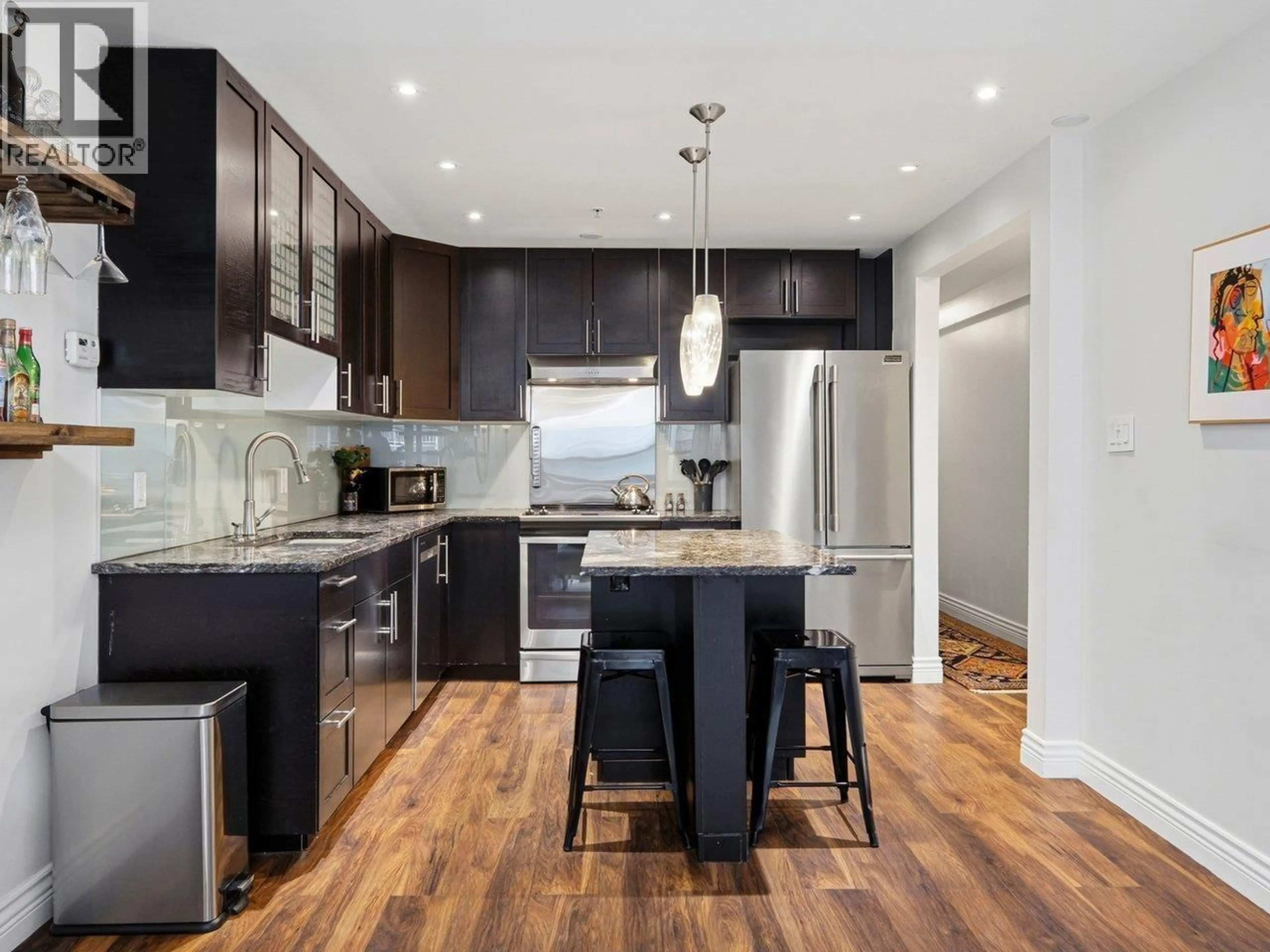 Contemporary kitchen, wood/laminate floor for 216 - 1549 KITCHENER STREET, Vancouver British Columbia V5L2V8