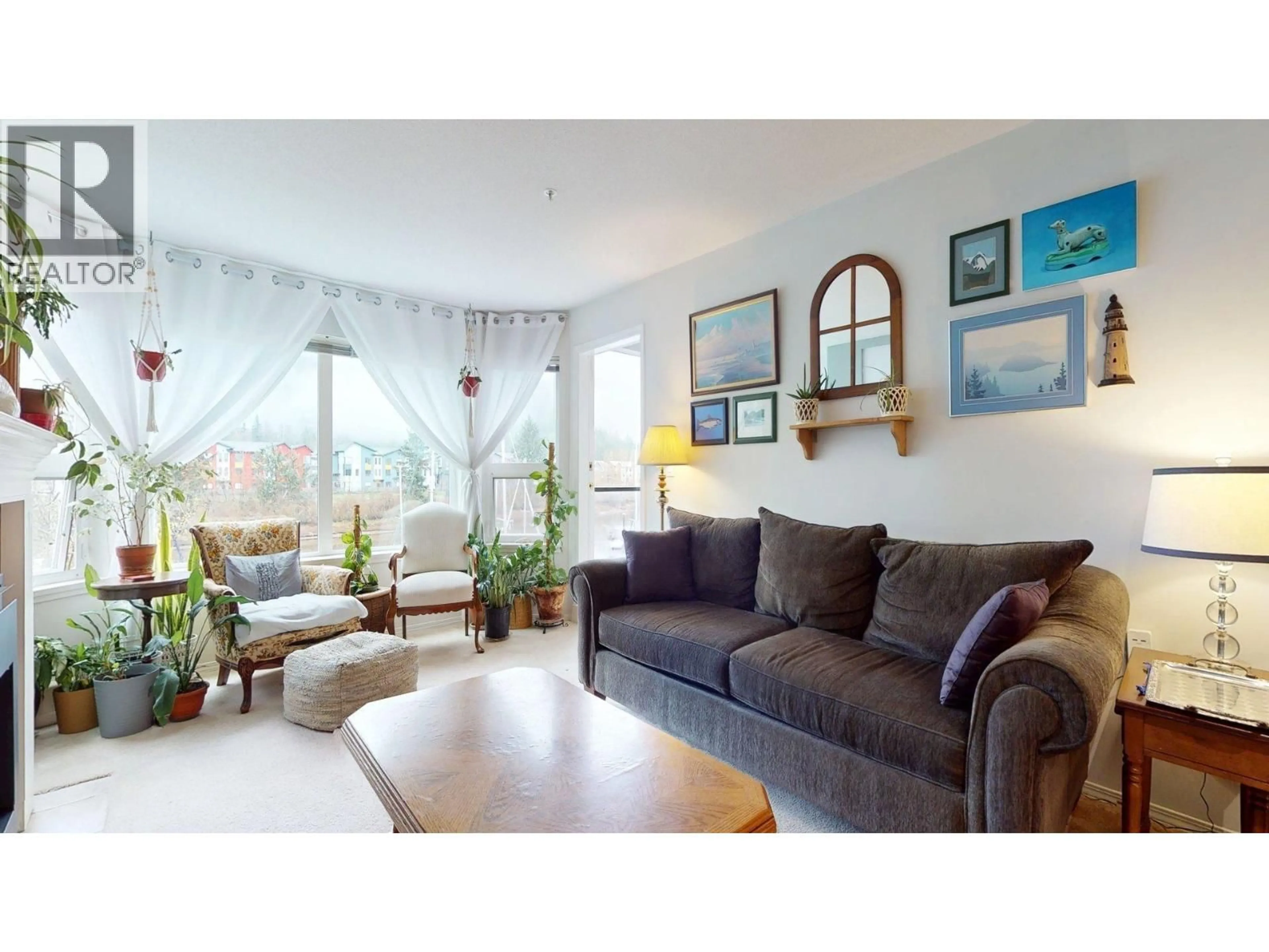 Living room with furniture, wood/laminate floor for 202 - 1468 PEMBERTON AVENUE, Squamish British Columbia V8B0K2