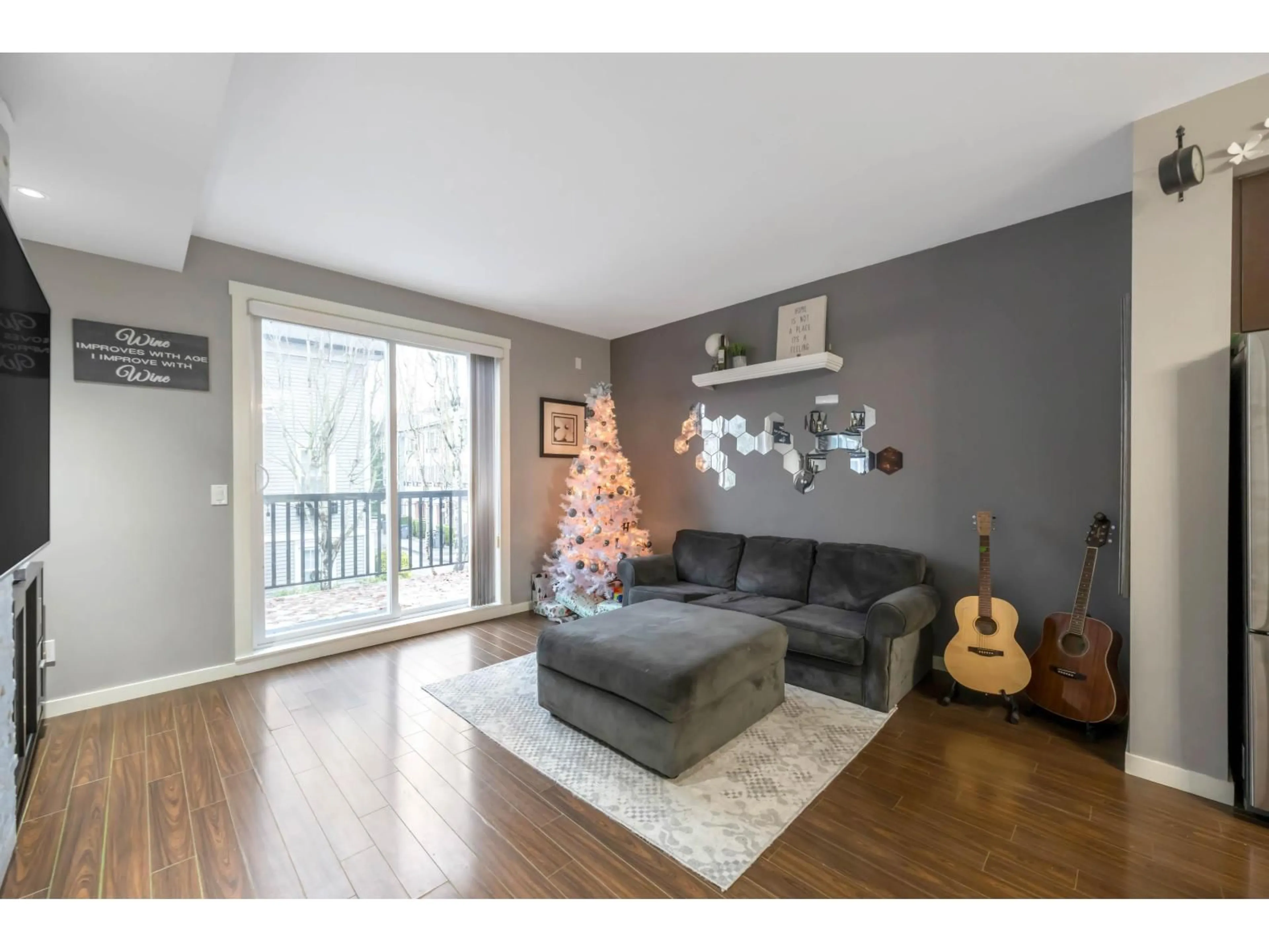 Living room with furniture, wood/laminate floor for 38 - 18983 72A AVENUE, Surrey British Columbia V4N1A5