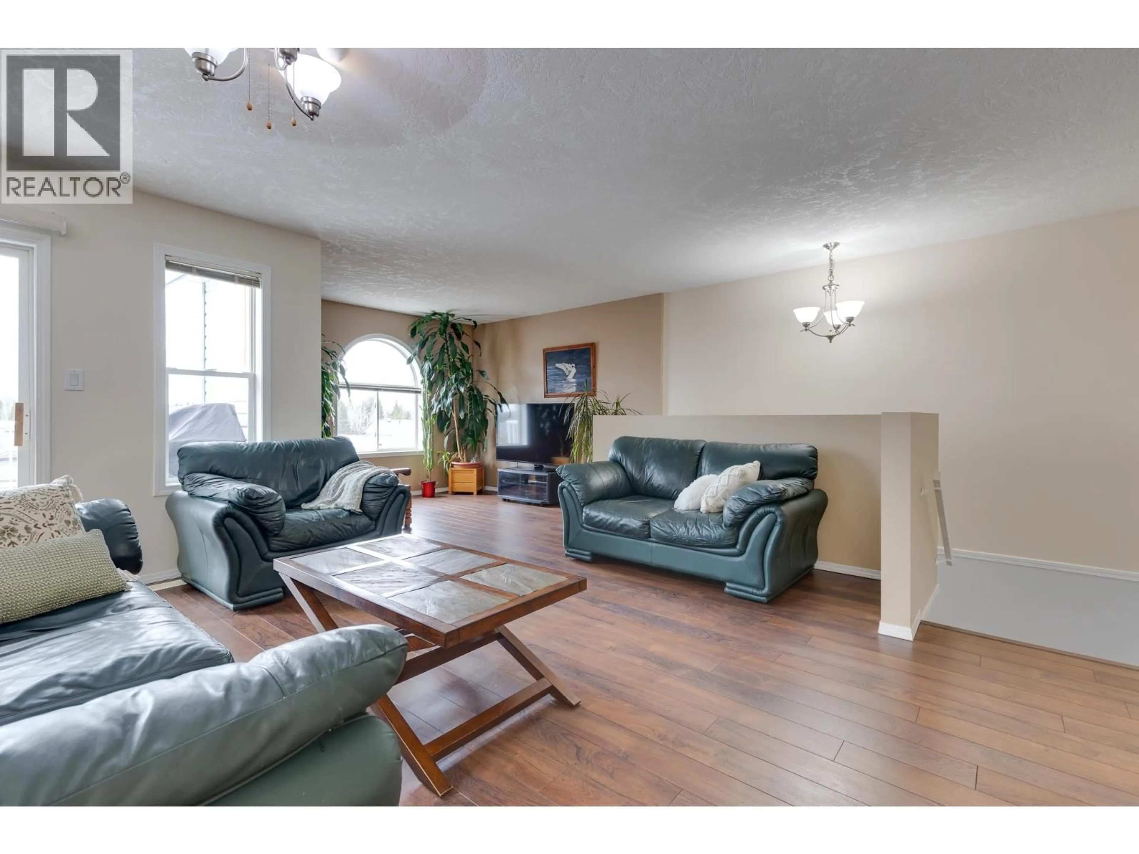 Living room with furniture, wood/laminate floor for 103 - 6855 DOMANAO BOULEVARD, Prince George British Columbia V2N5C9