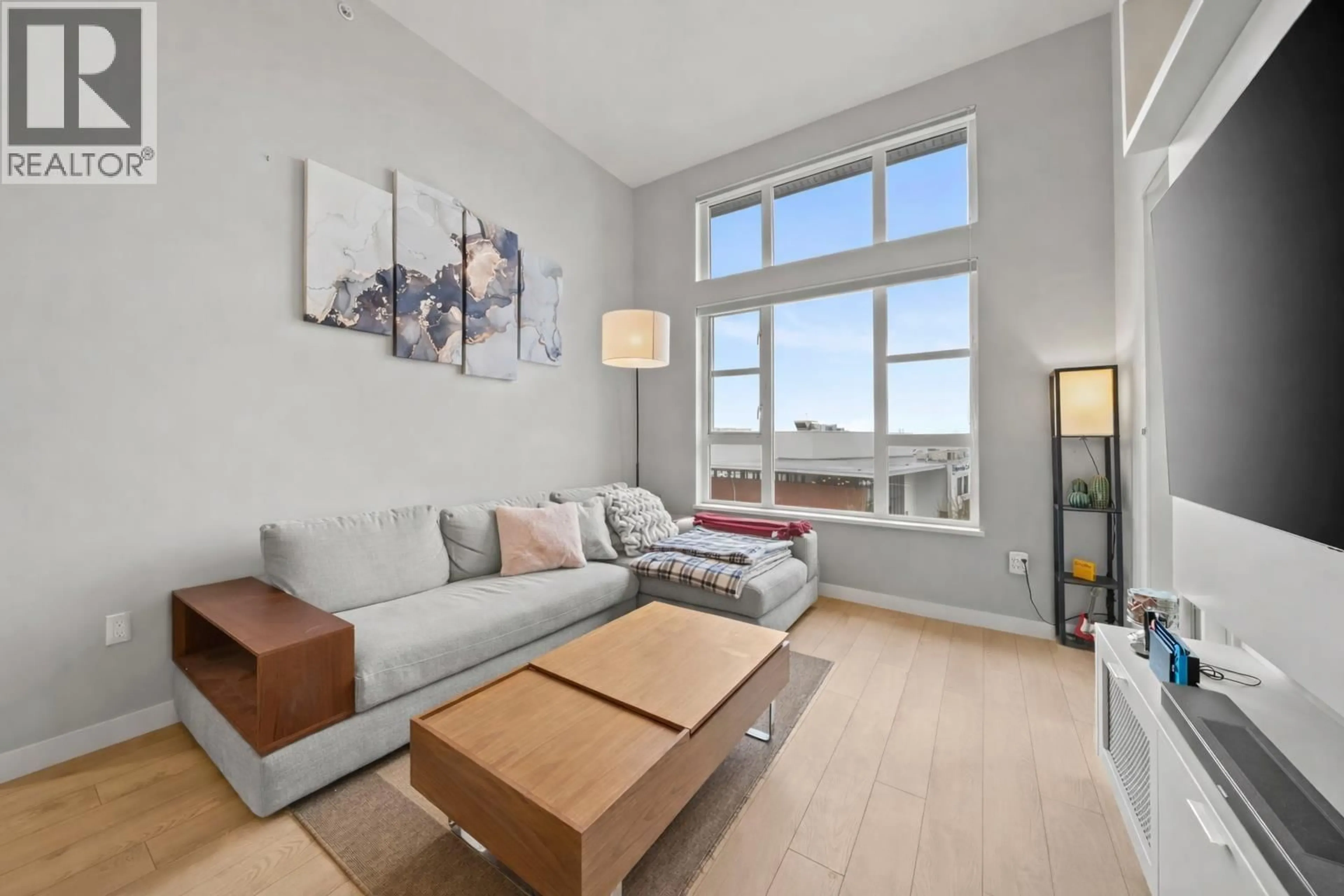 Living room with furniture, wood/laminate floor for 416 - 550 SEABORNE PLACE, Port Coquitlam British Columbia V3B0L3