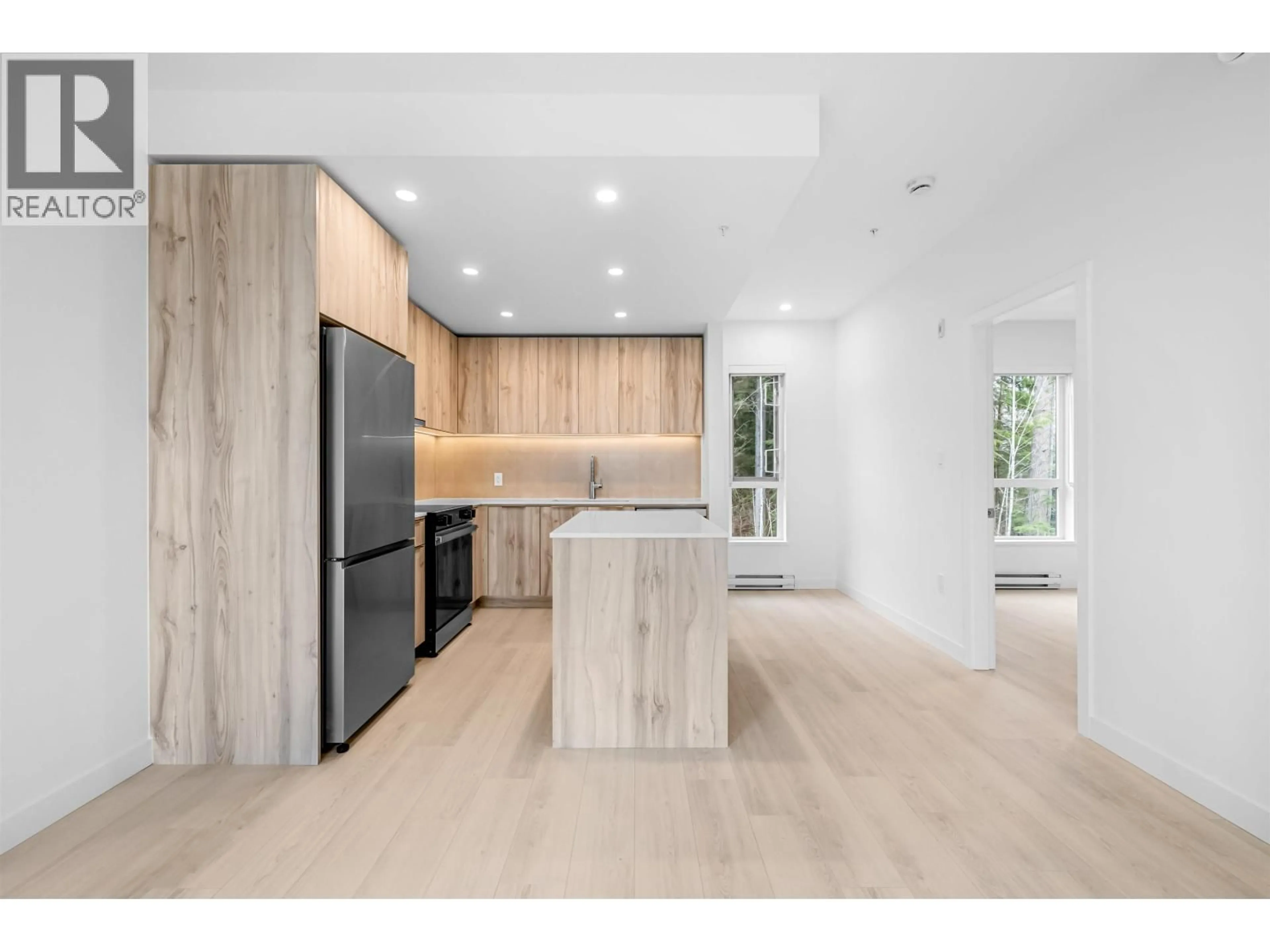 Open concept kitchen, wood/laminate floor for 408 - 3596 MALSUM DRIVE, North Vancouver British Columbia V7G0B2