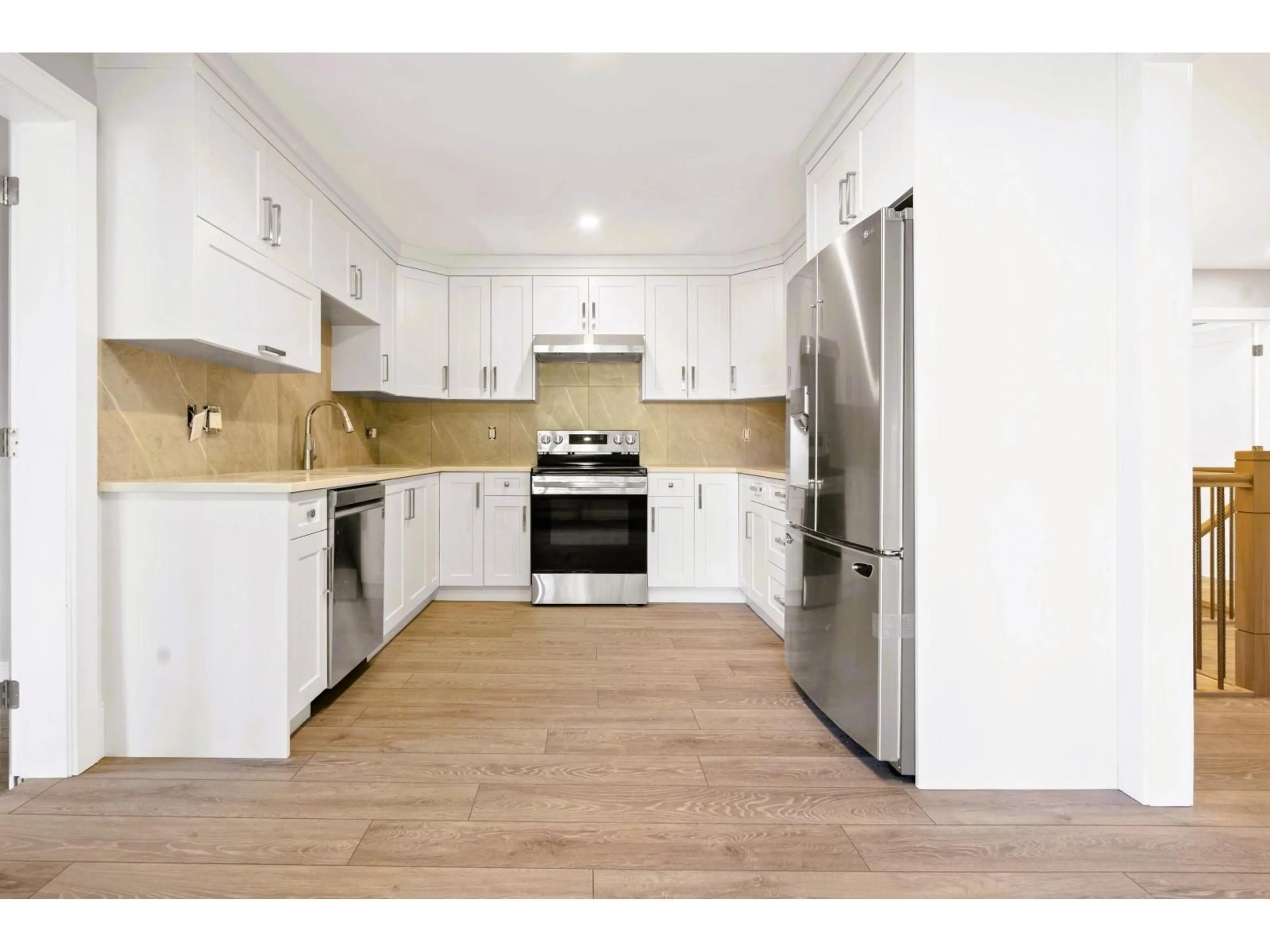 Open concept kitchen, wood/laminate floor for 8589 112 STREET, Delta British Columbia V4C4X1