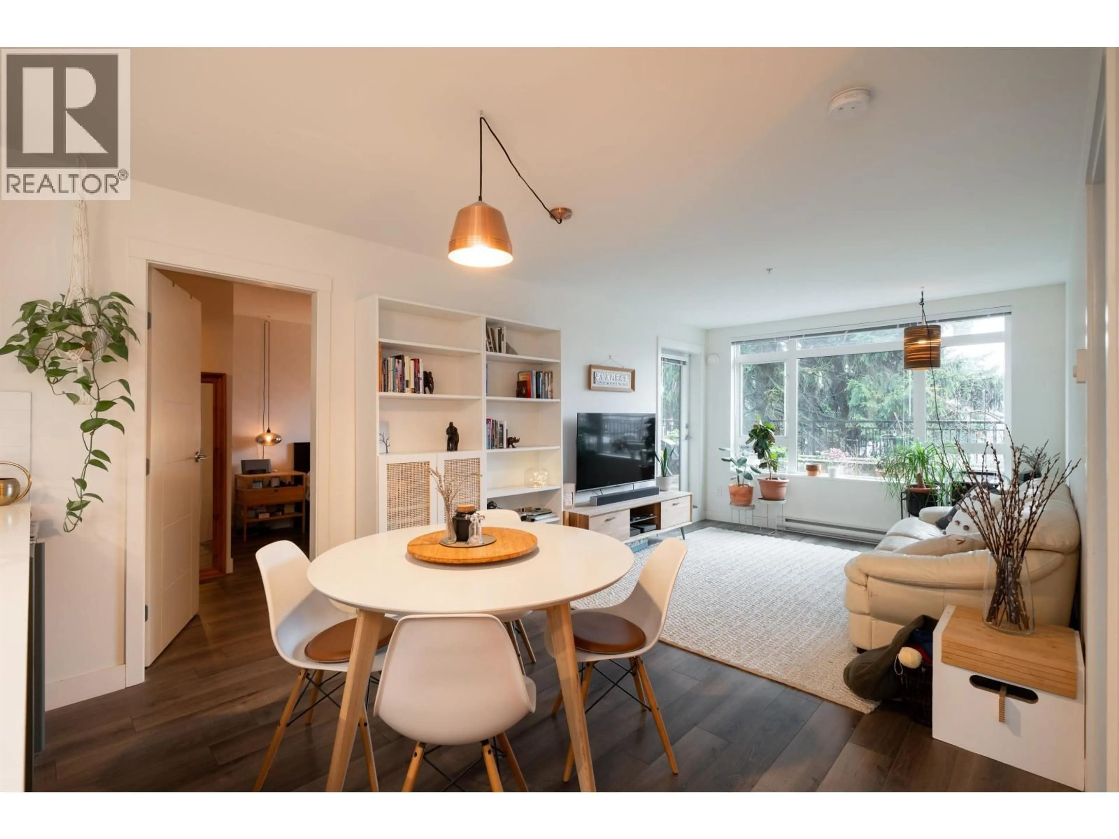 Living room with furniture, wood/laminate floor for 215 - 2525 CLARKE STREET, Port Moody British Columbia V3H0J3