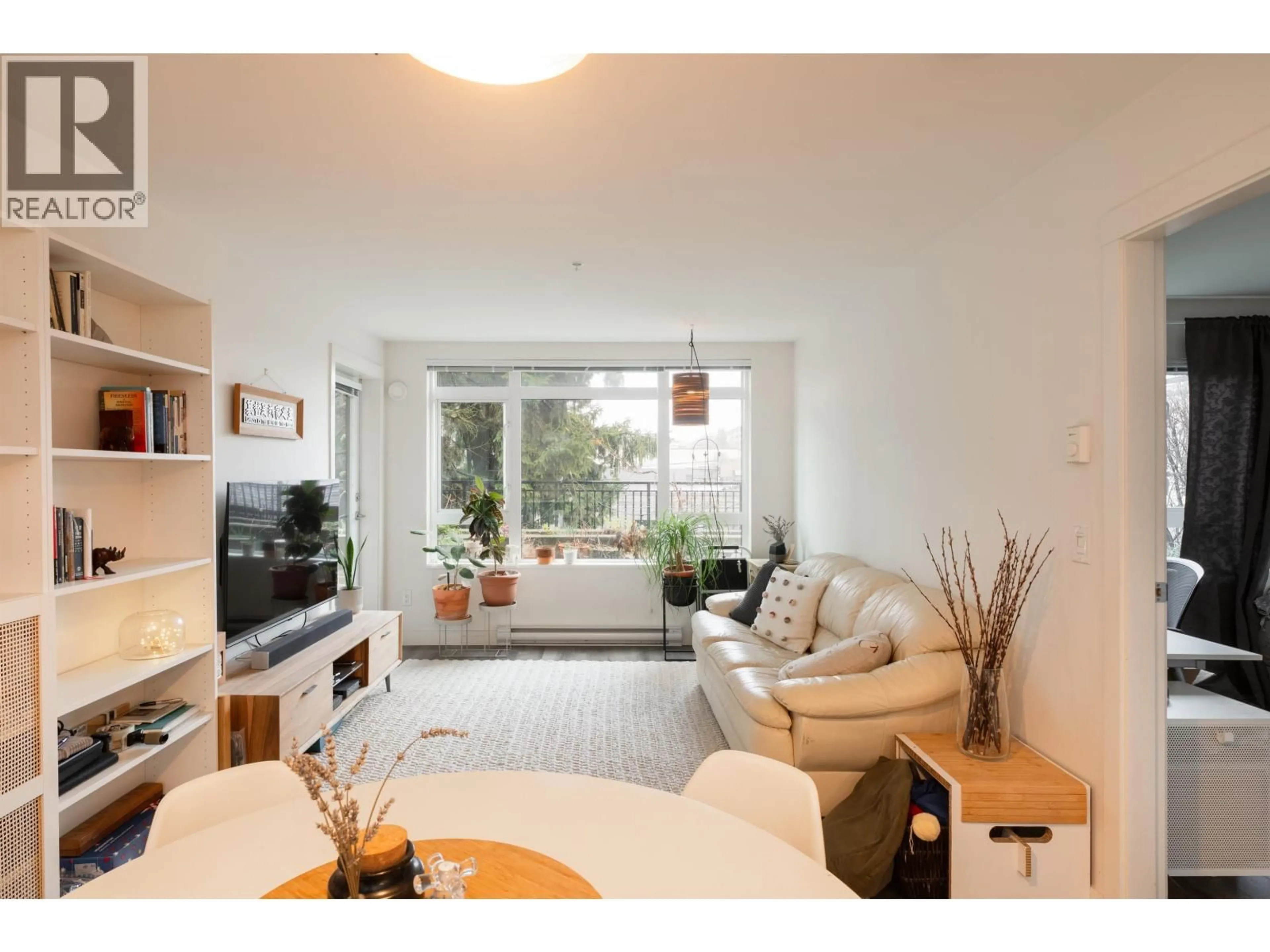 Living room with furniture, wood/laminate floor for 215 - 2525 CLARKE STREET, Port Moody British Columbia V3H0J3