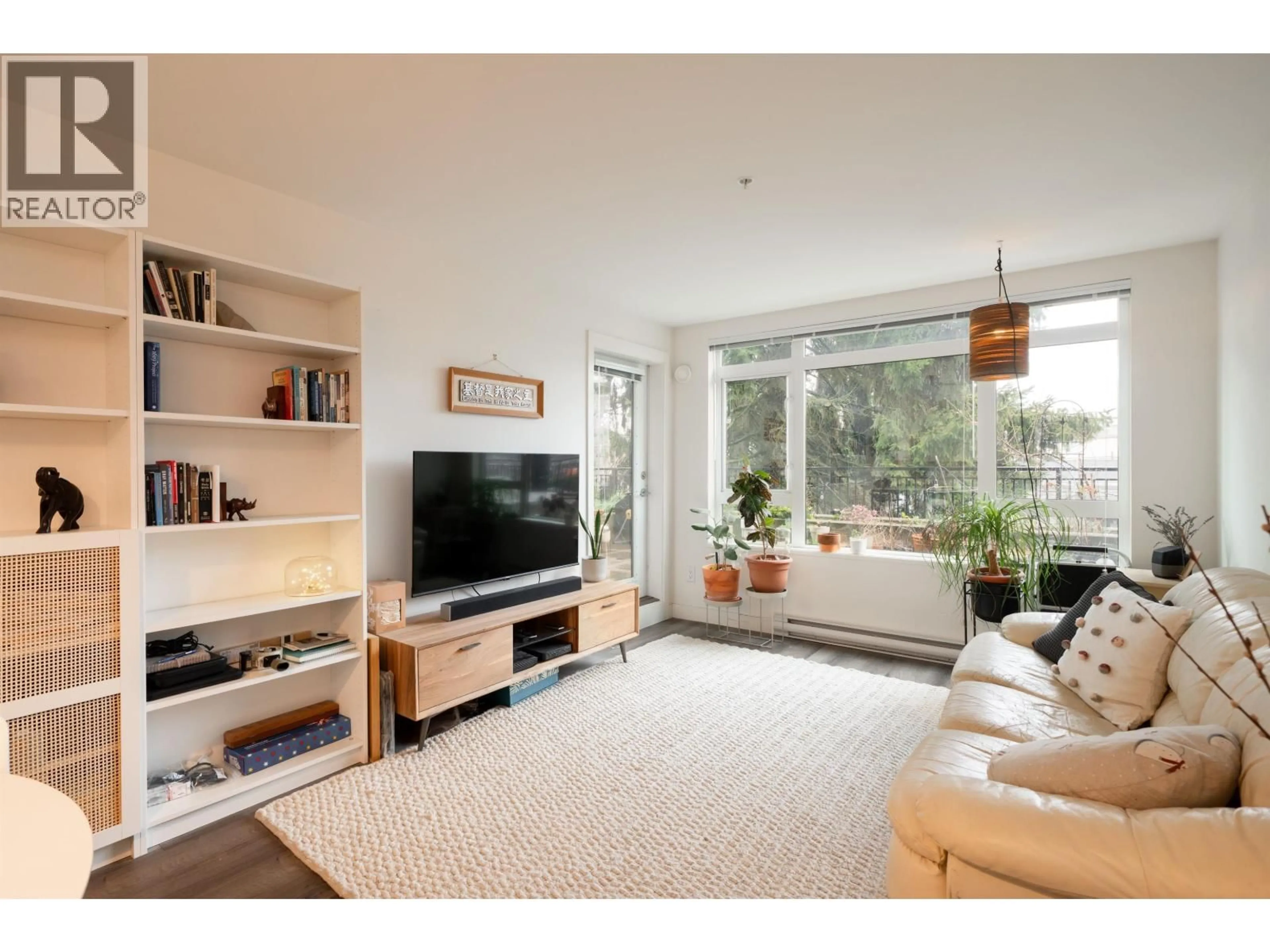 Living room with furniture, wood/laminate floor for 215 - 2525 CLARKE STREET, Port Moody British Columbia V3H0J3