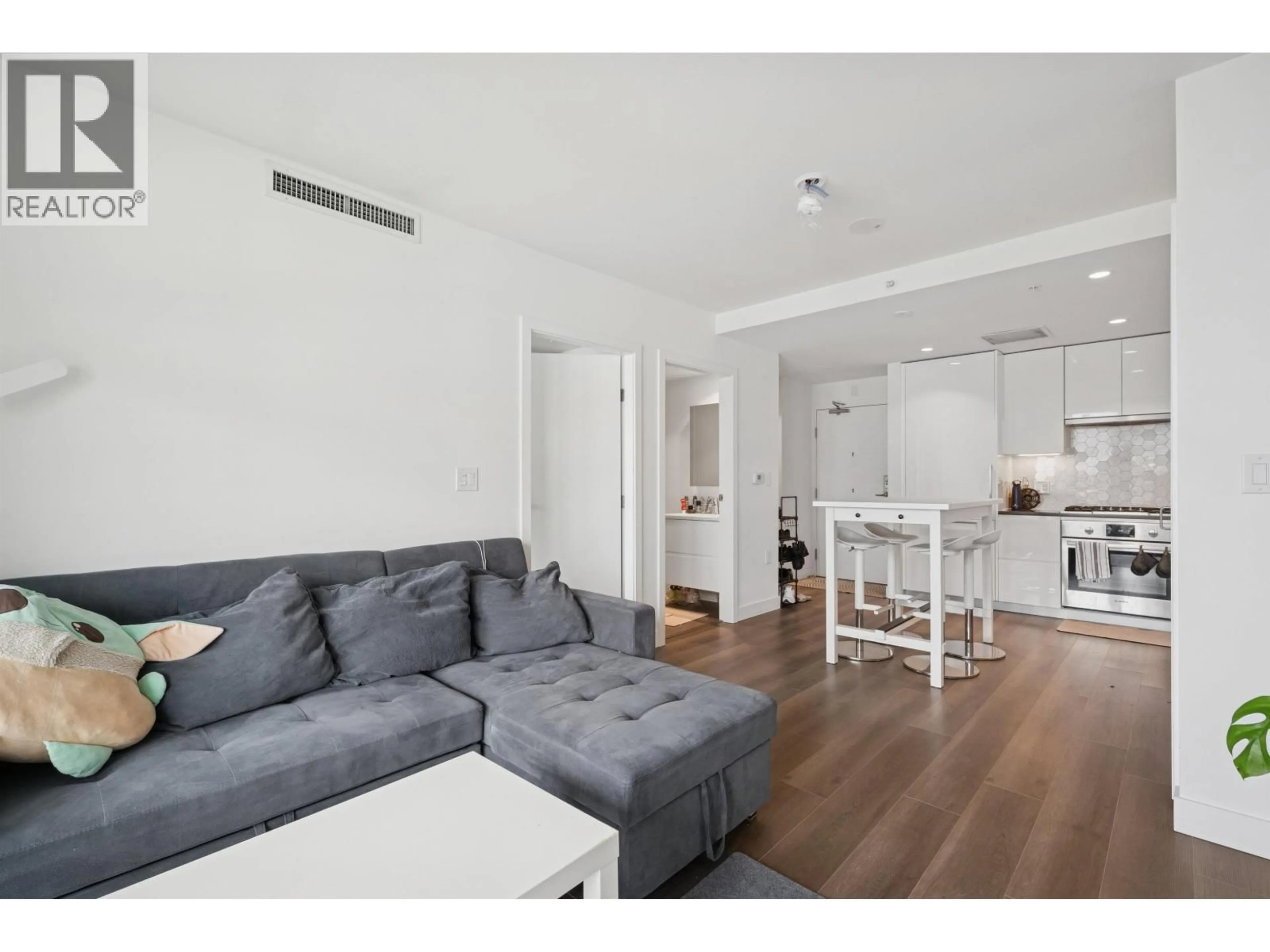 Living room with furniture, wood/laminate floor for 506 - 8121 CHESTER STREET, Vancouver British Columbia V5X0J9