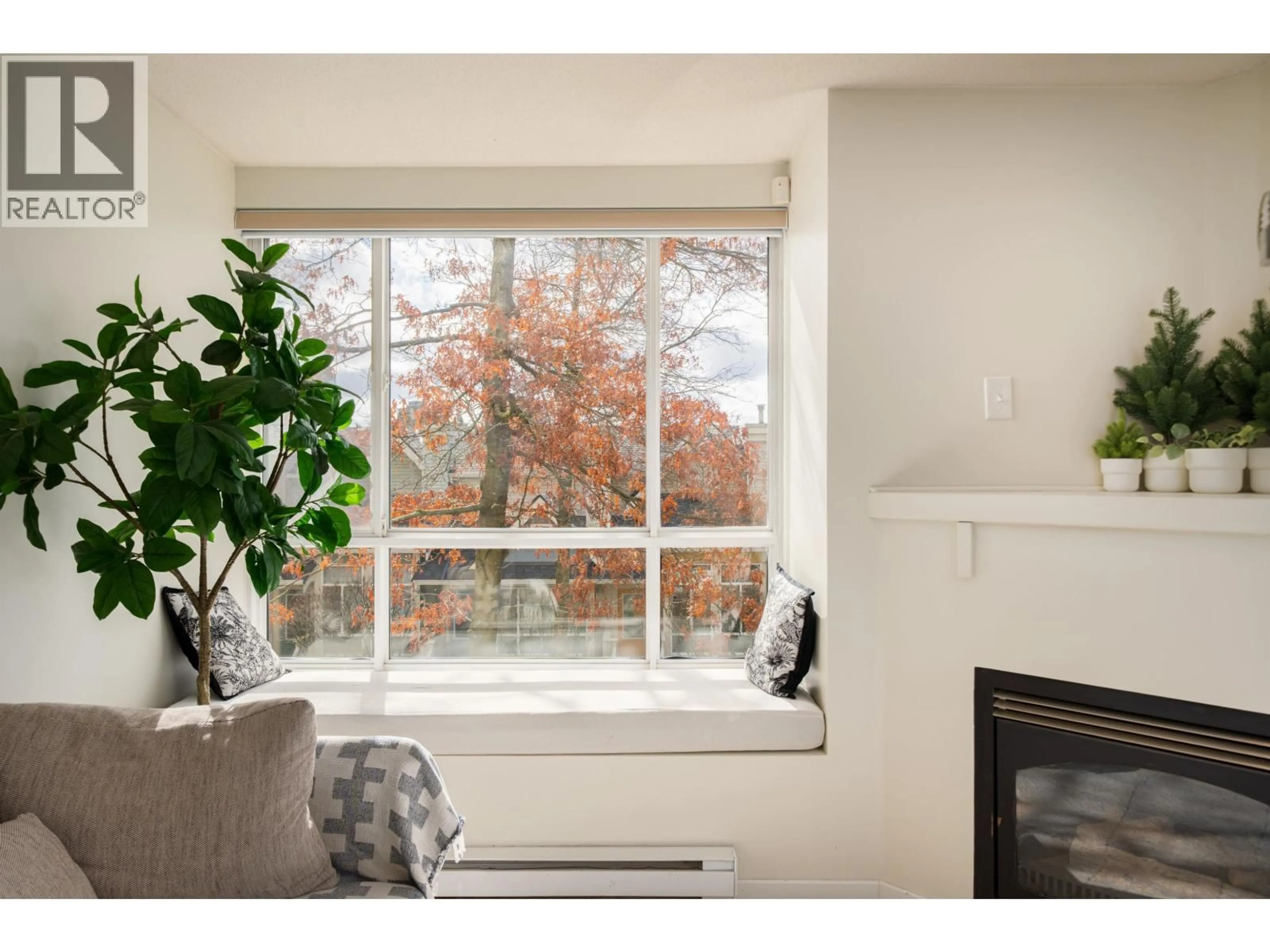 Living room with furniture, wood/laminate floor for 204 - 6833 VILLAGE, Burnaby British Columbia V5E4M1