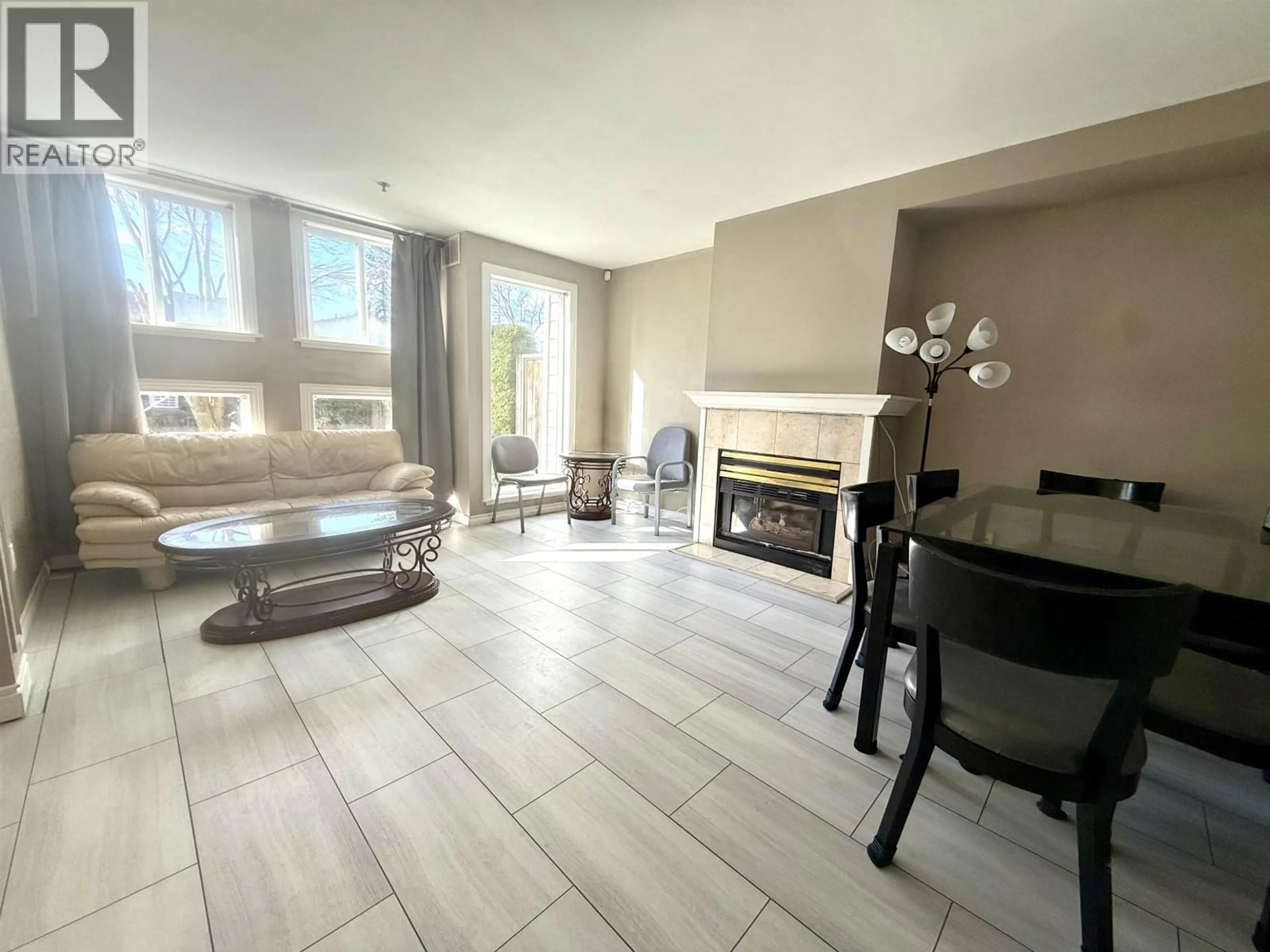 Living room with furniture, ceramic/tile floor for 105 - 7288 NO. 3 ROAD, Richmond British Columbia V6Y3Y1