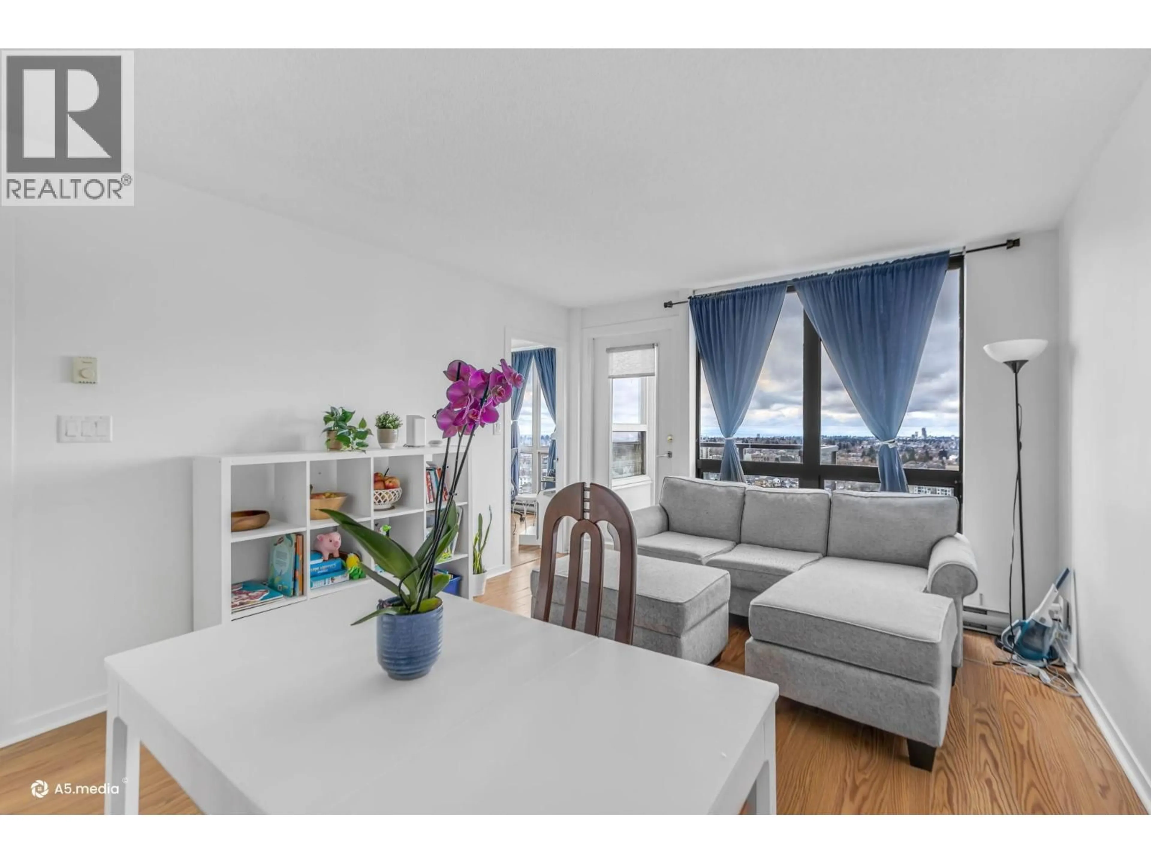 Living room with furniture, wood/laminate floor for 2508 - 3663 CROWLEY DRIVE, Vancouver British Columbia V5R6H4