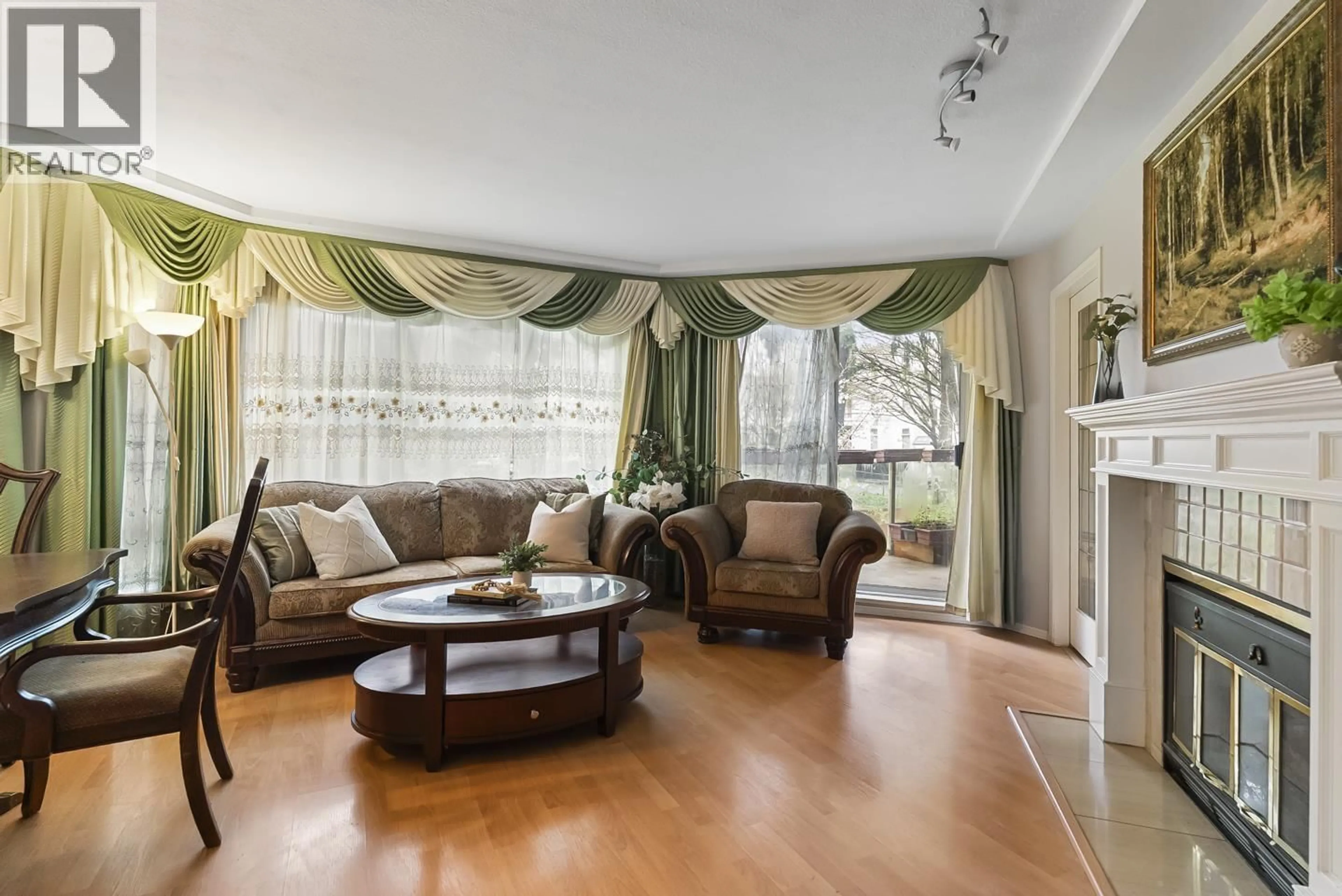 Living room with furniture, wood/laminate floor for 108 - 8611 ACKROYD ROAD, Richmond British Columbia V6X3P4