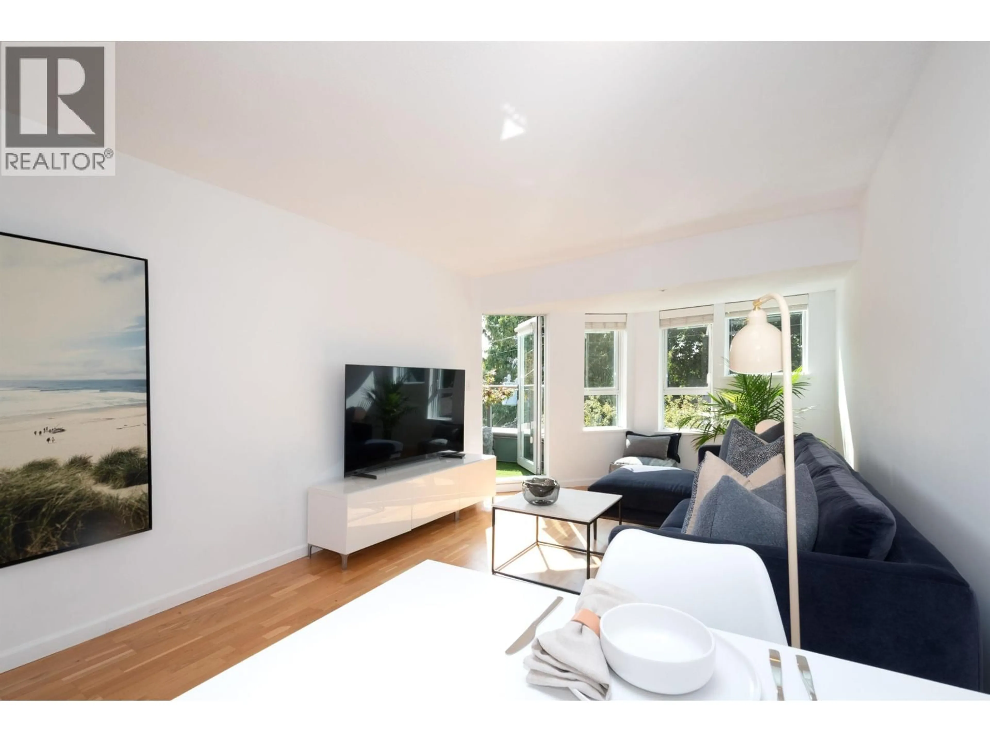 Living room with furniture, wood/laminate floor for 420 - 3440 BROADWAY, Vancouver British Columbia V6R4R2