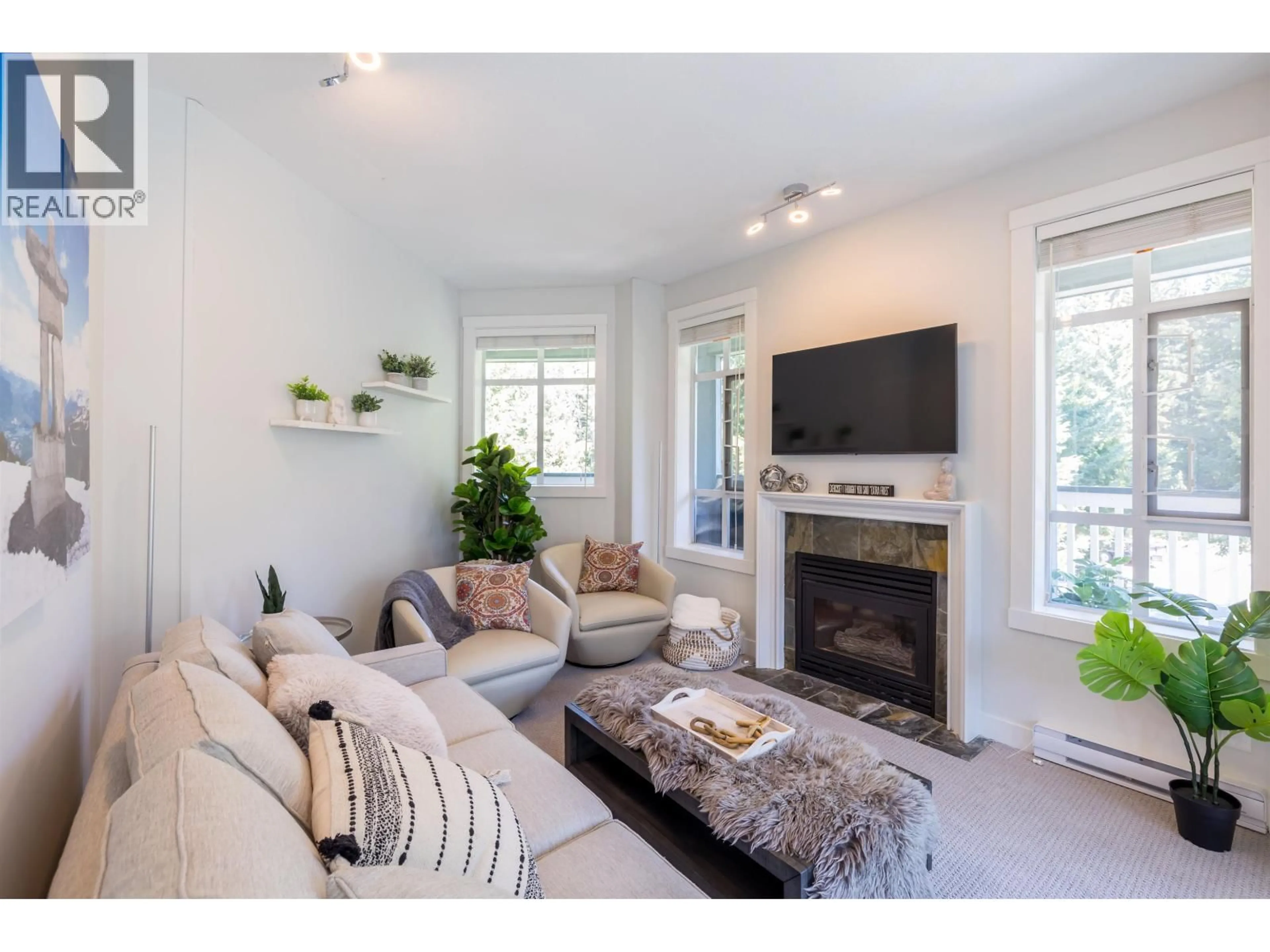Living room with furniture, wood/laminate floor for 311 - 4405 BLACKCOMB WAY, Whistler British Columbia V3S9E5