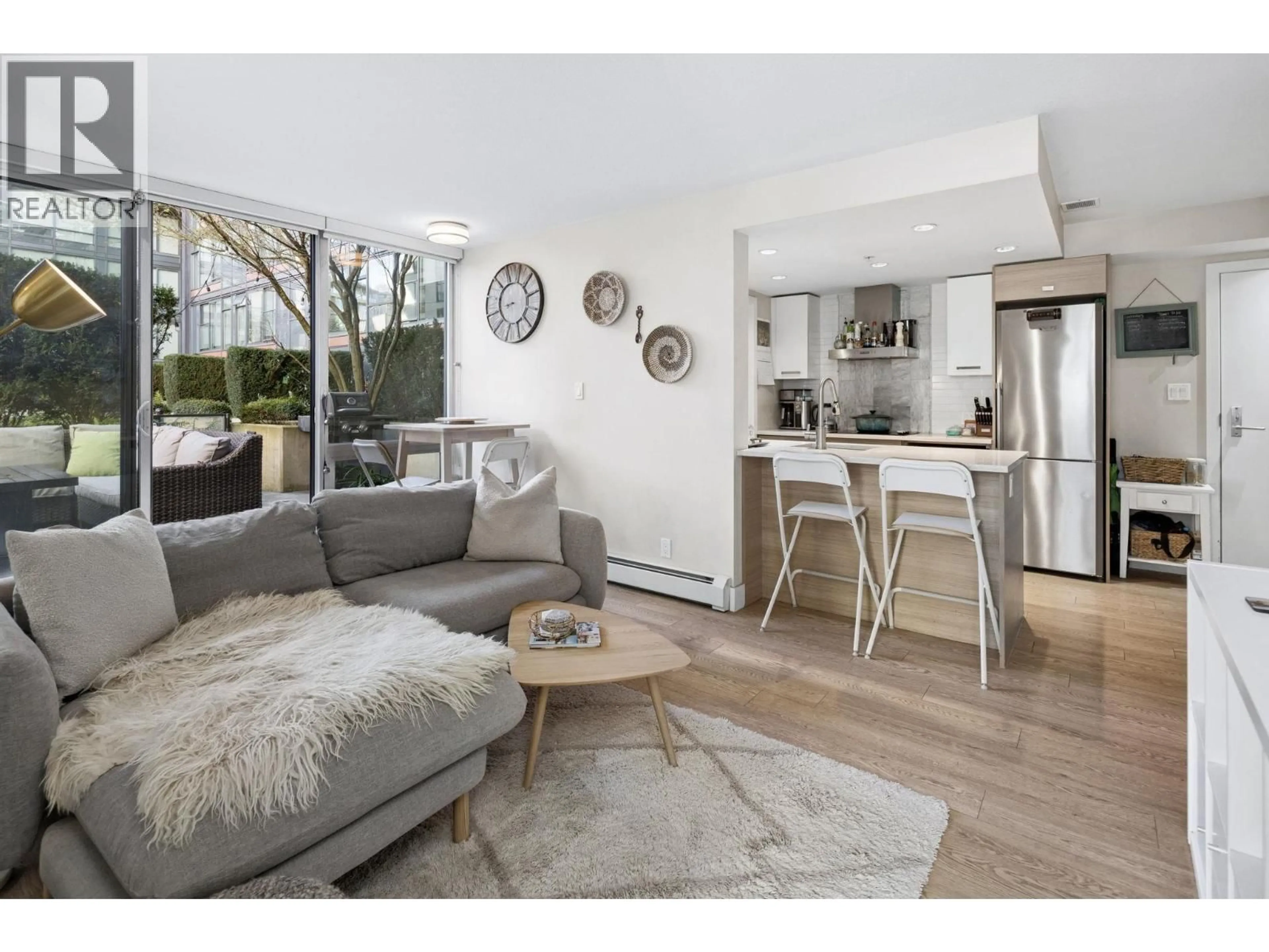 Living room with furniture, wood/laminate floor for 220 - 1783 MANITOBA STREET, Vancouver British Columbia V5Y0K1