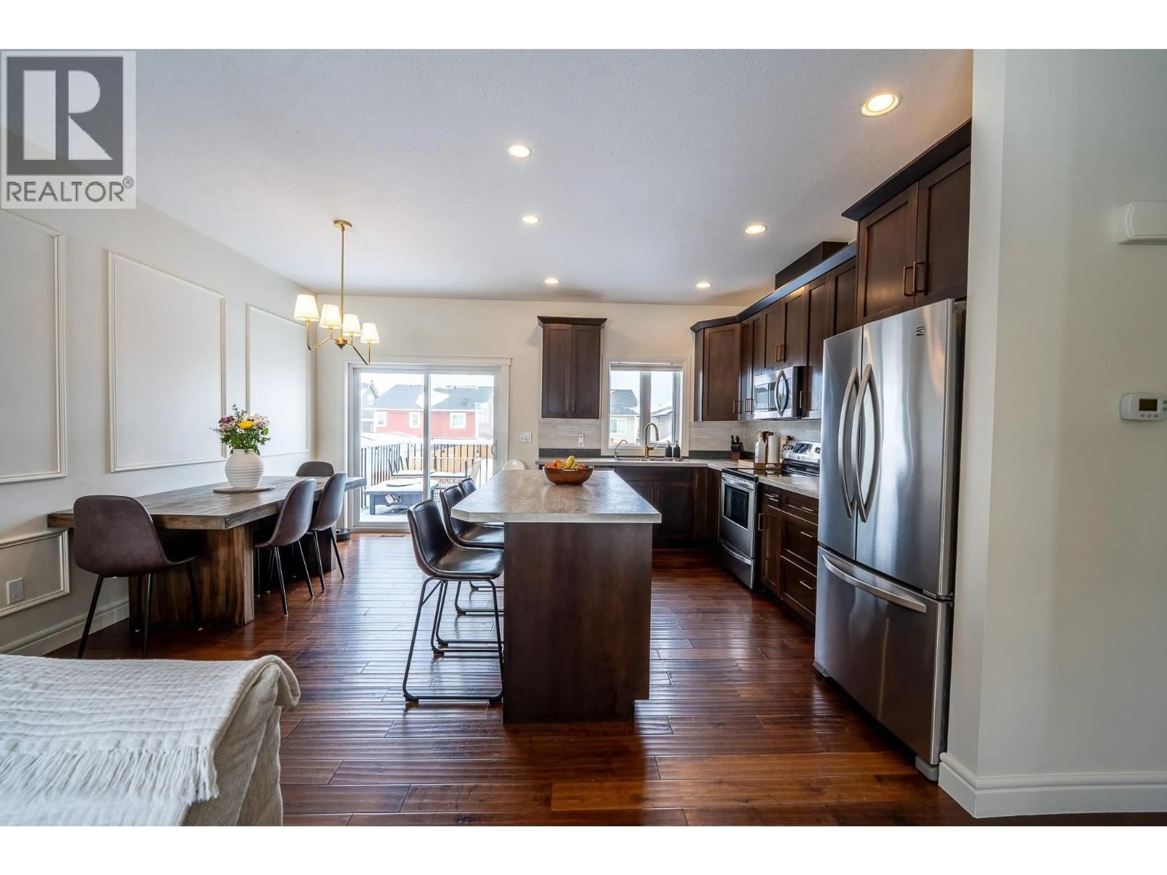 Open concept kitchen, wood/laminate floor for 8324 85 AVENUE, Fort St. John British Columbia V1J0G3