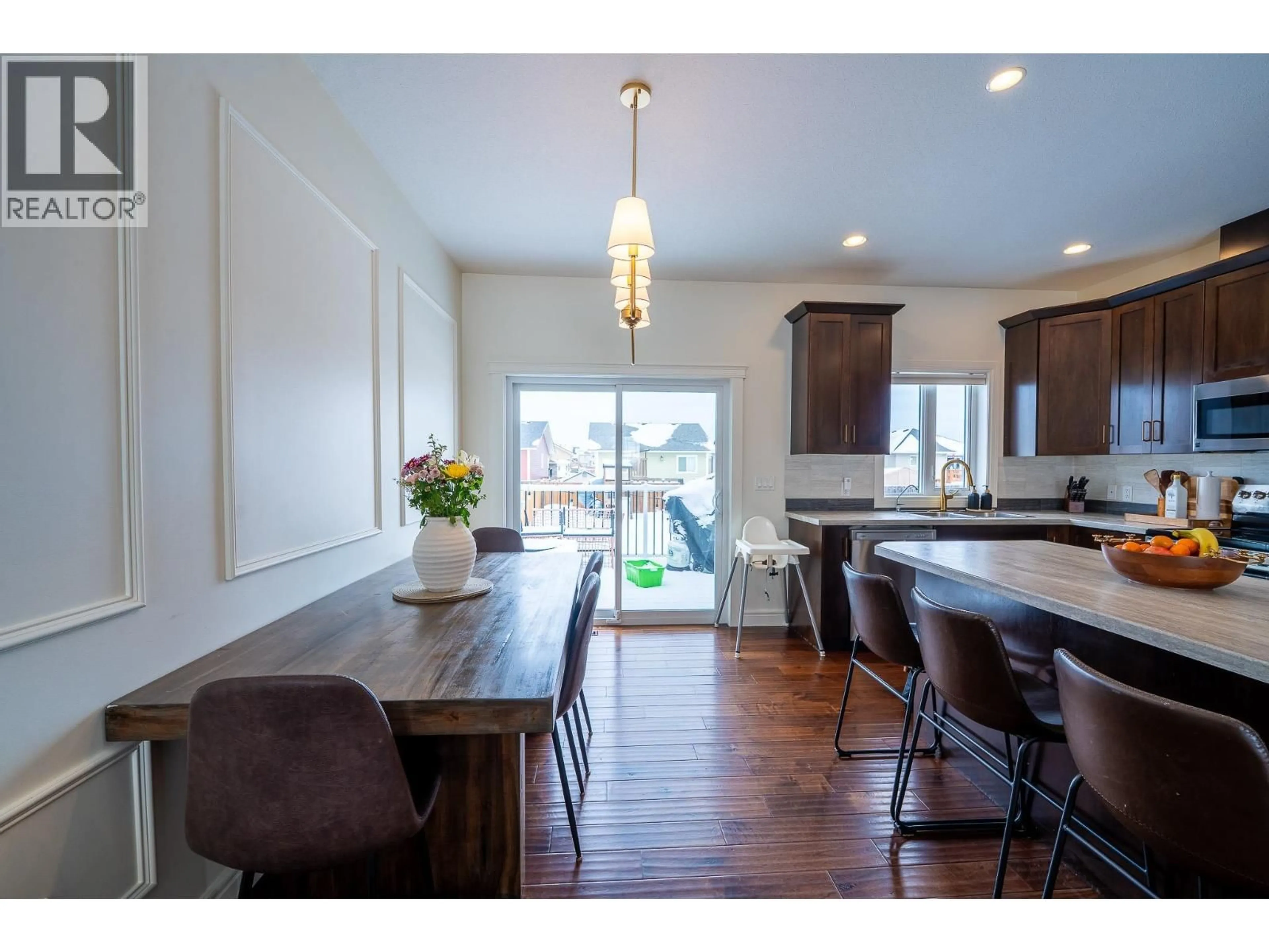 Open concept kitchen, wood/laminate floor for 8324 85 AVENUE, Fort St. John British Columbia V1J0G3