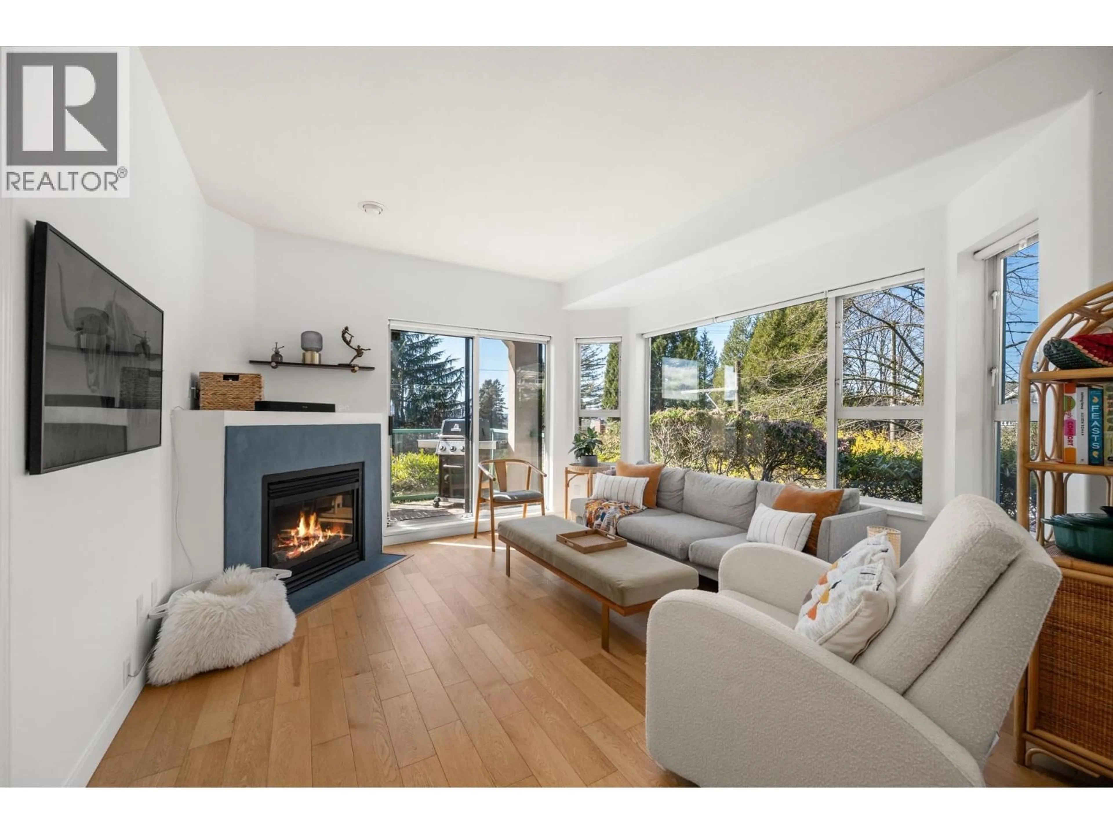 Living room with furniture, wood/laminate floor for 103 - 177 5TH STREET, North Vancouver British Columbia V7M1J6