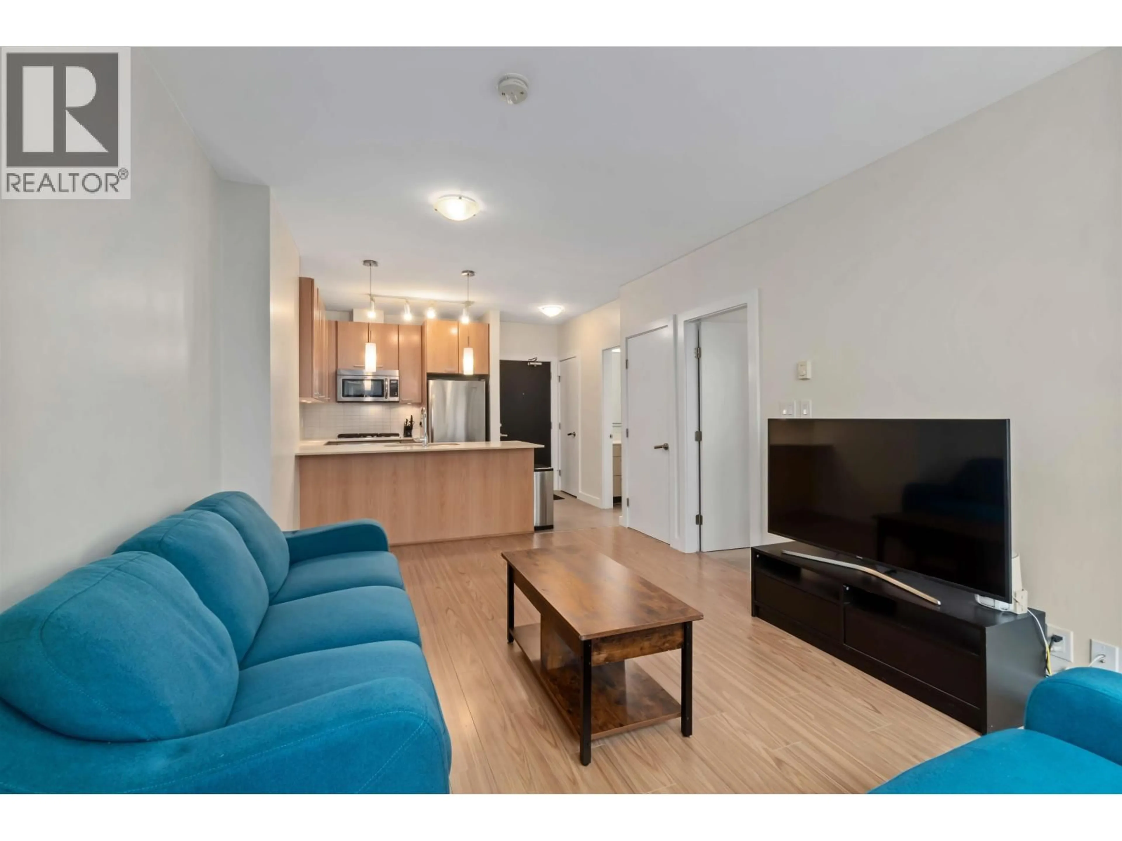 Living room with furniture, wood/laminate floor for 1603 - 2955 ATLANTIC AVENUE, Coquitlam British Columbia V3B0H9