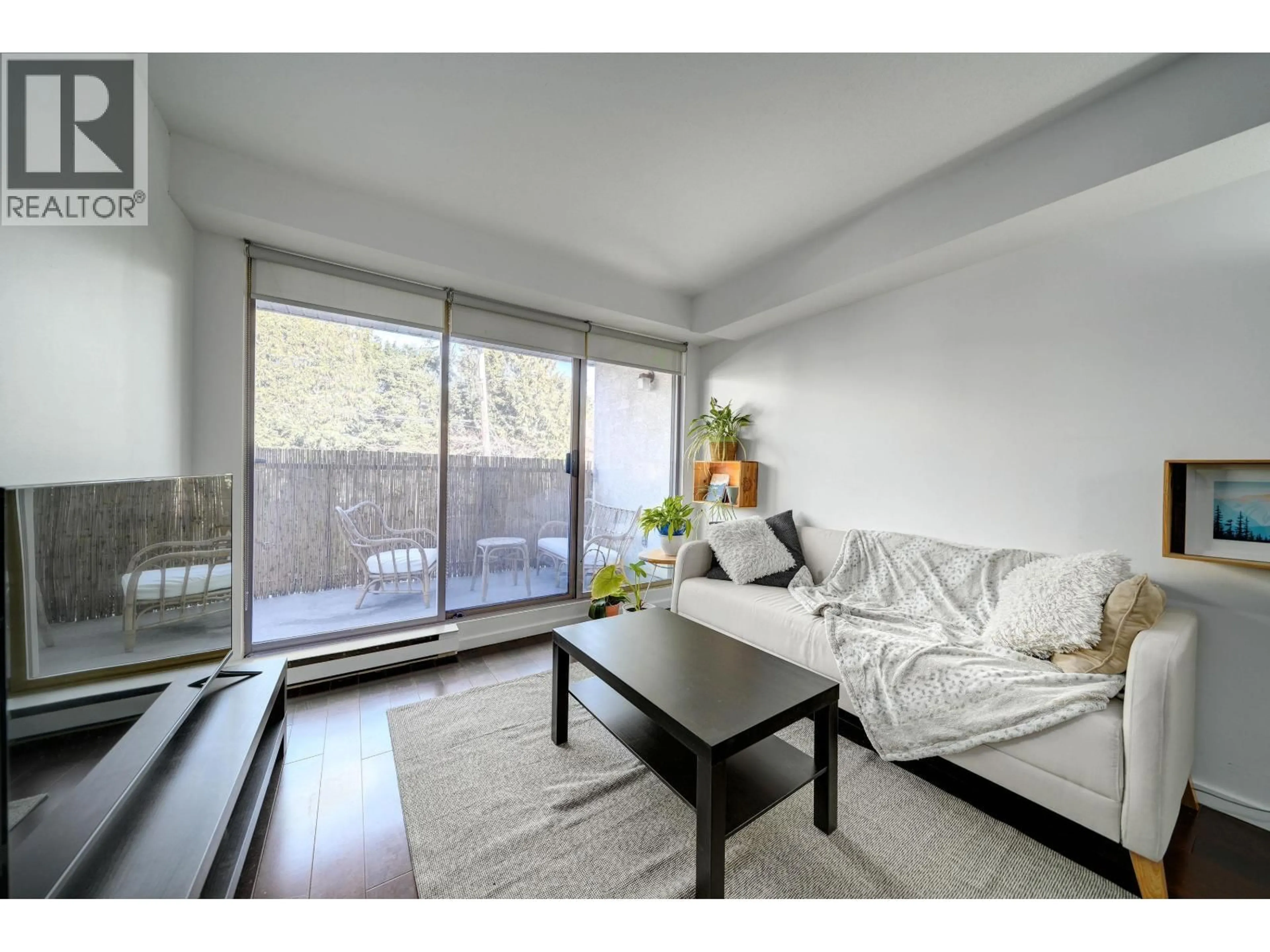 Living room with furniture, wood/laminate floor for 210 - 1099 BROADWAY, Vancouver British Columbia V5T1Y5