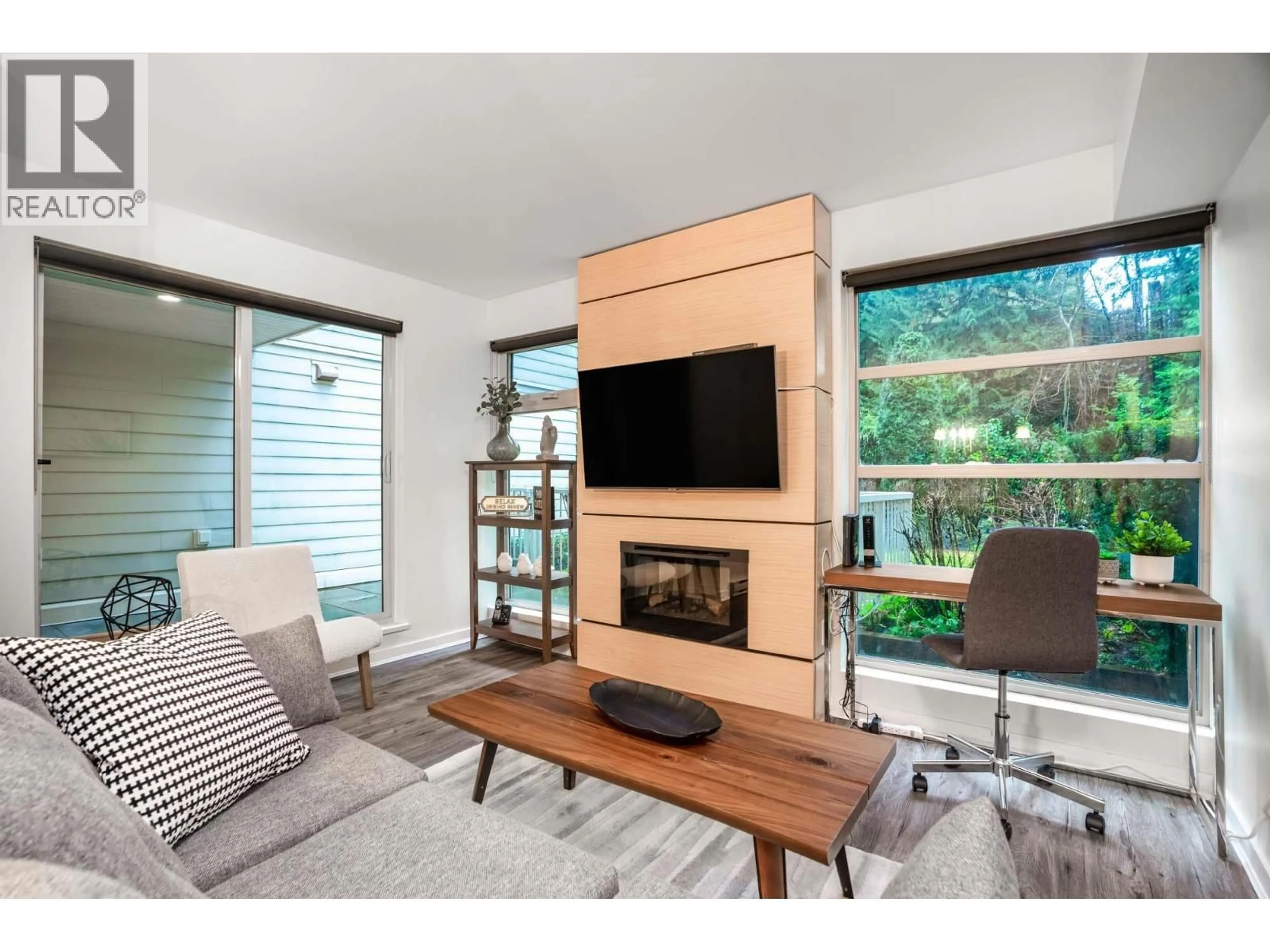 Living room with furniture, wood/laminate floor for 104 - 2832 CAPILANO ROAD, North Vancouver British Columbia V7R4H5