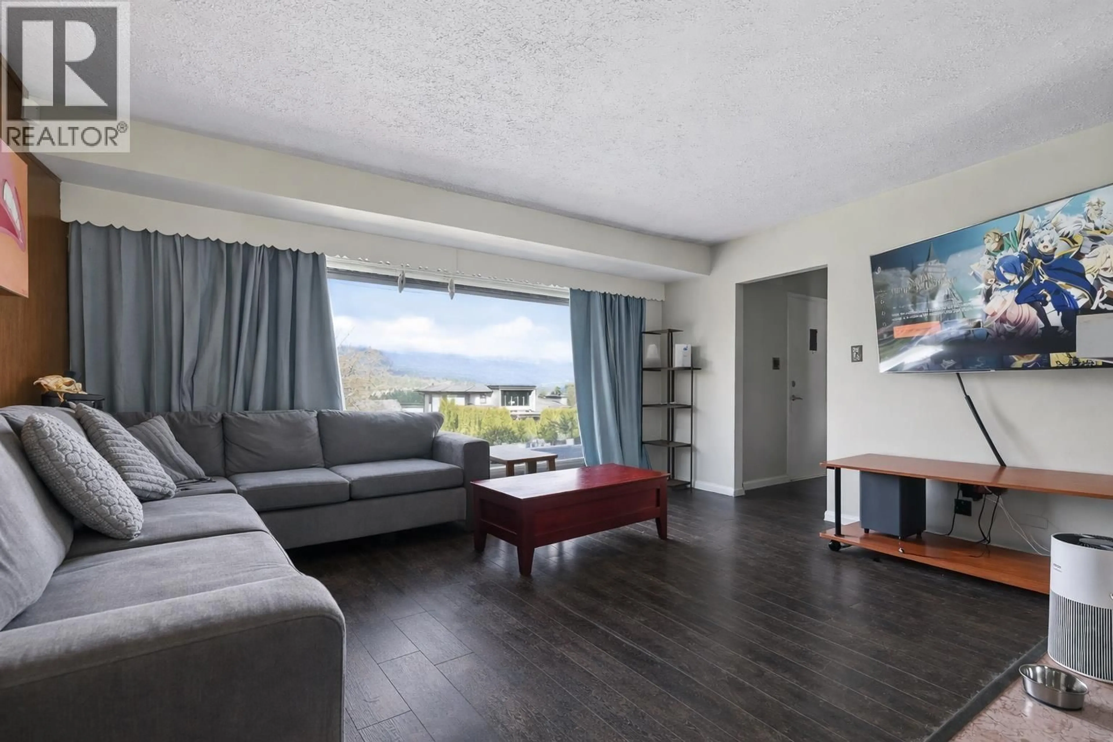 Living room with furniture, wood/laminate floor for 7016 SIERRA DRIVE, Burnaby British Columbia V5A1A5