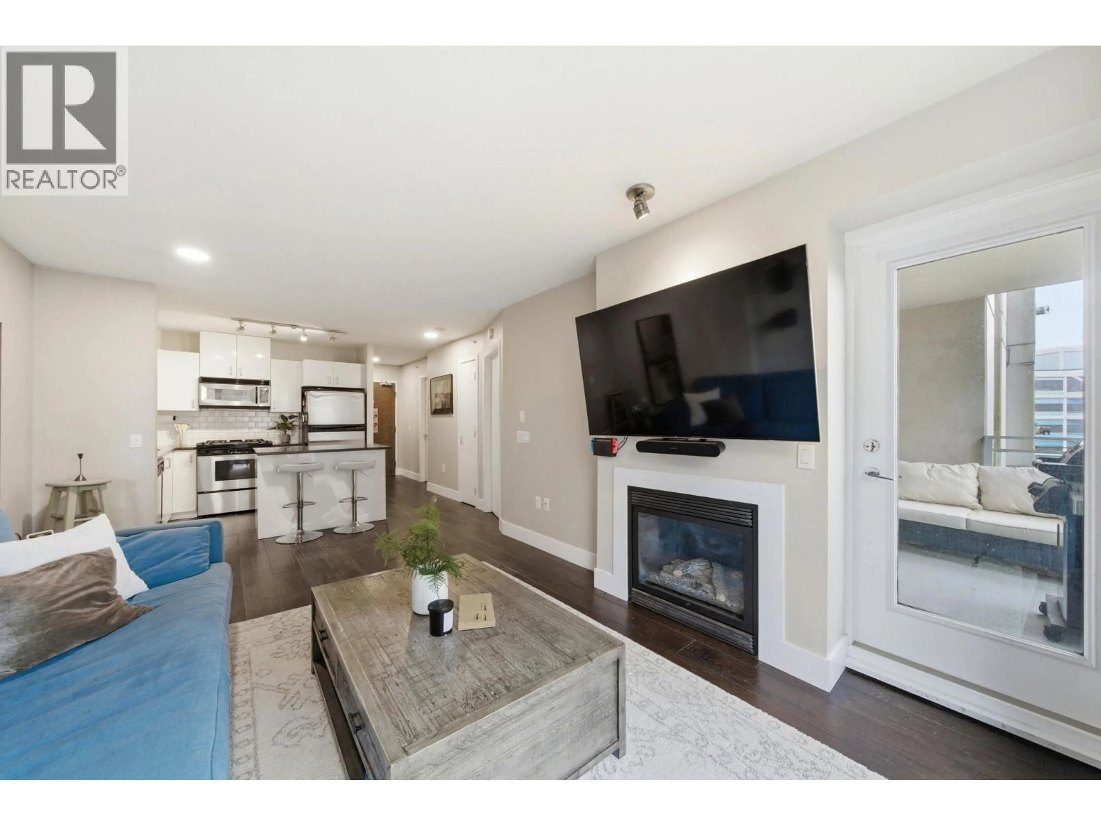 Living room with furniture, wood/laminate floor for 405 - 155 1ST STREET, North Vancouver British Columbia V7M3N8