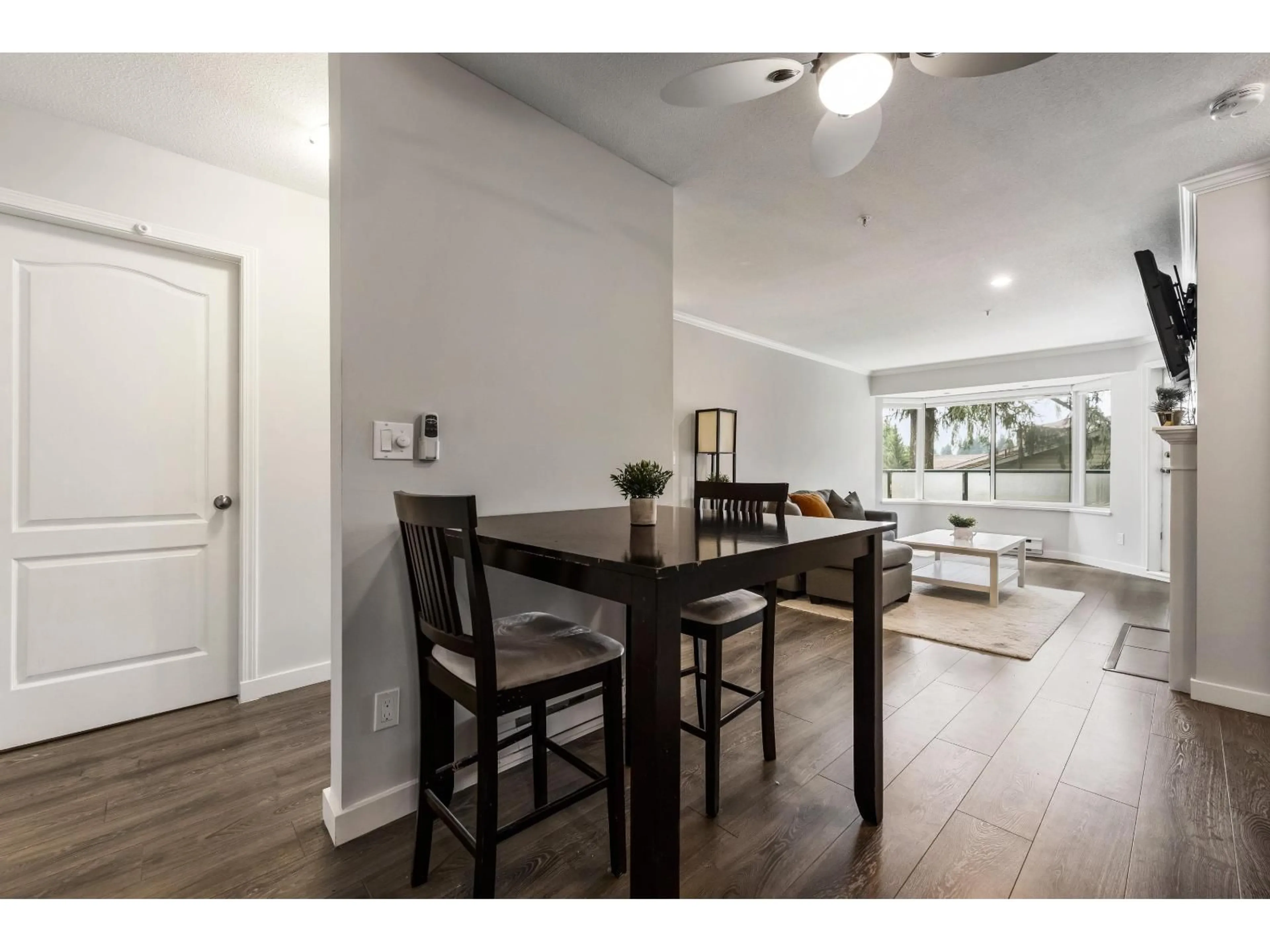 Dining room, wood/laminate floor for 403 - 2958 TRETHEWEY STREET, Abbotsford British Columbia V2T6P6