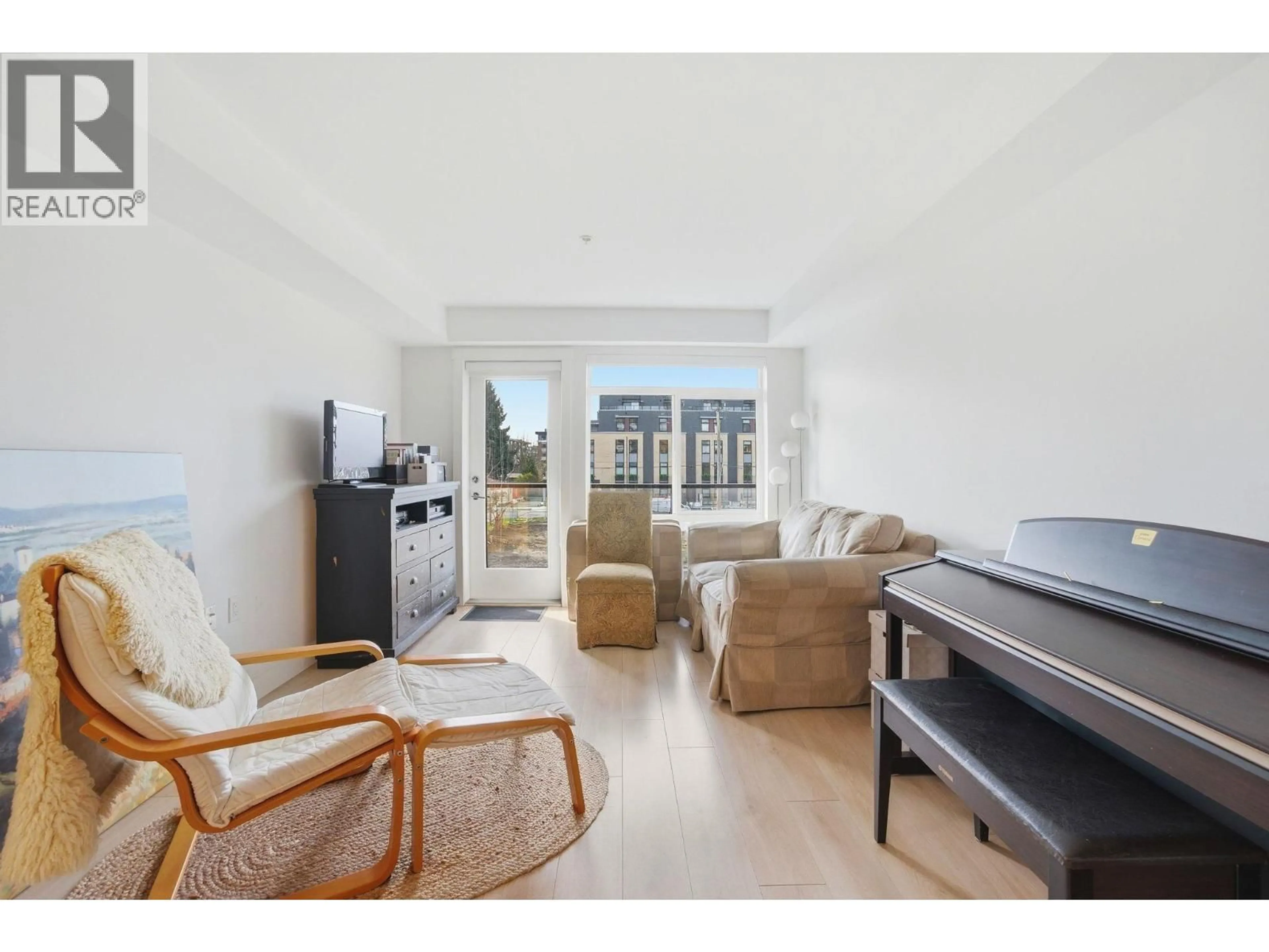 Living room with furniture, wood/laminate floor for 204 - 1519 CROWN STREET, North Vancouver British Columbia V7J1G6