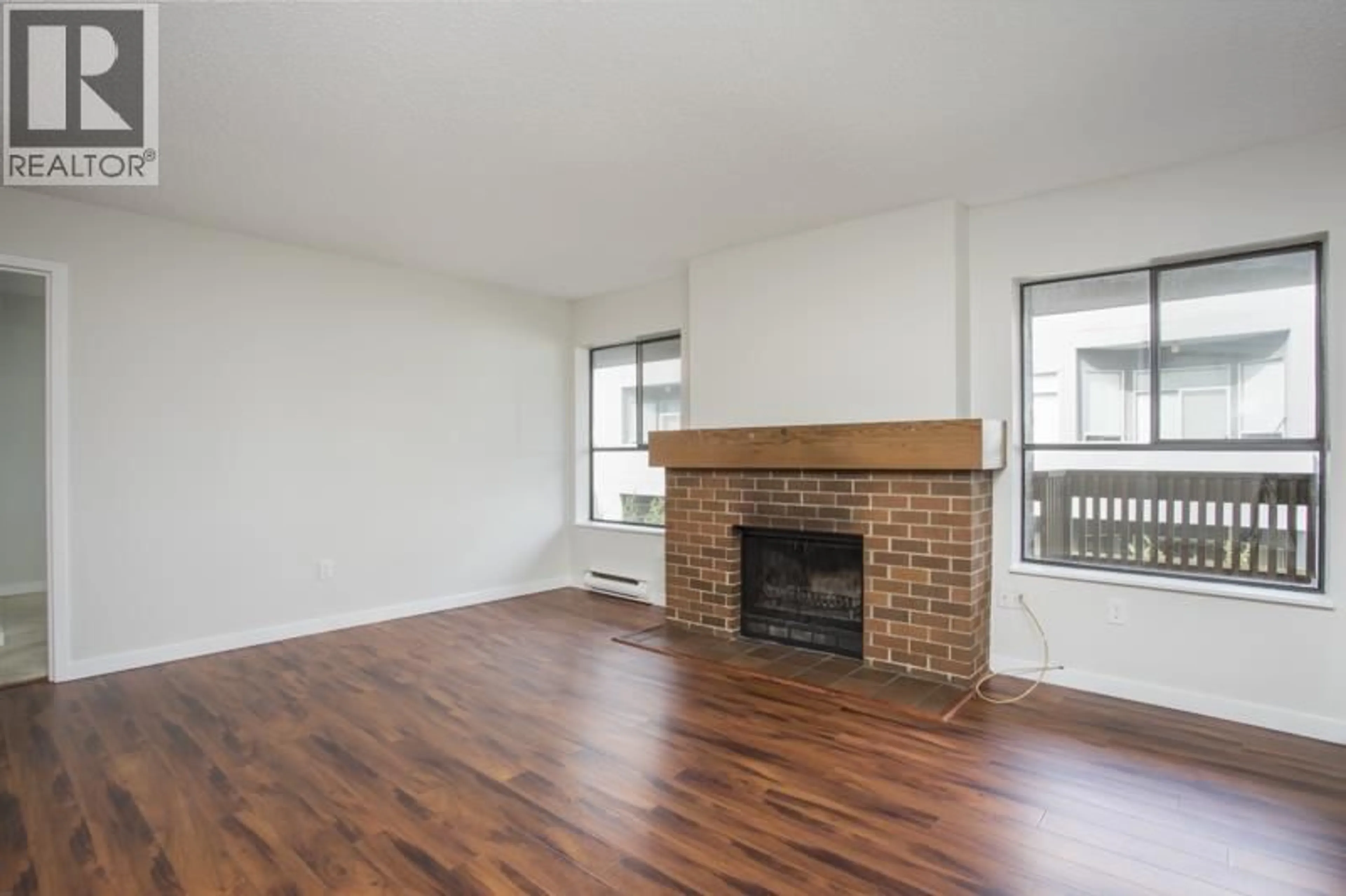 Living room with furniture, wood/laminate floor for 214 - 7411 MINORU BOULEVARD, Richmond British Columbia V6Y1Z3