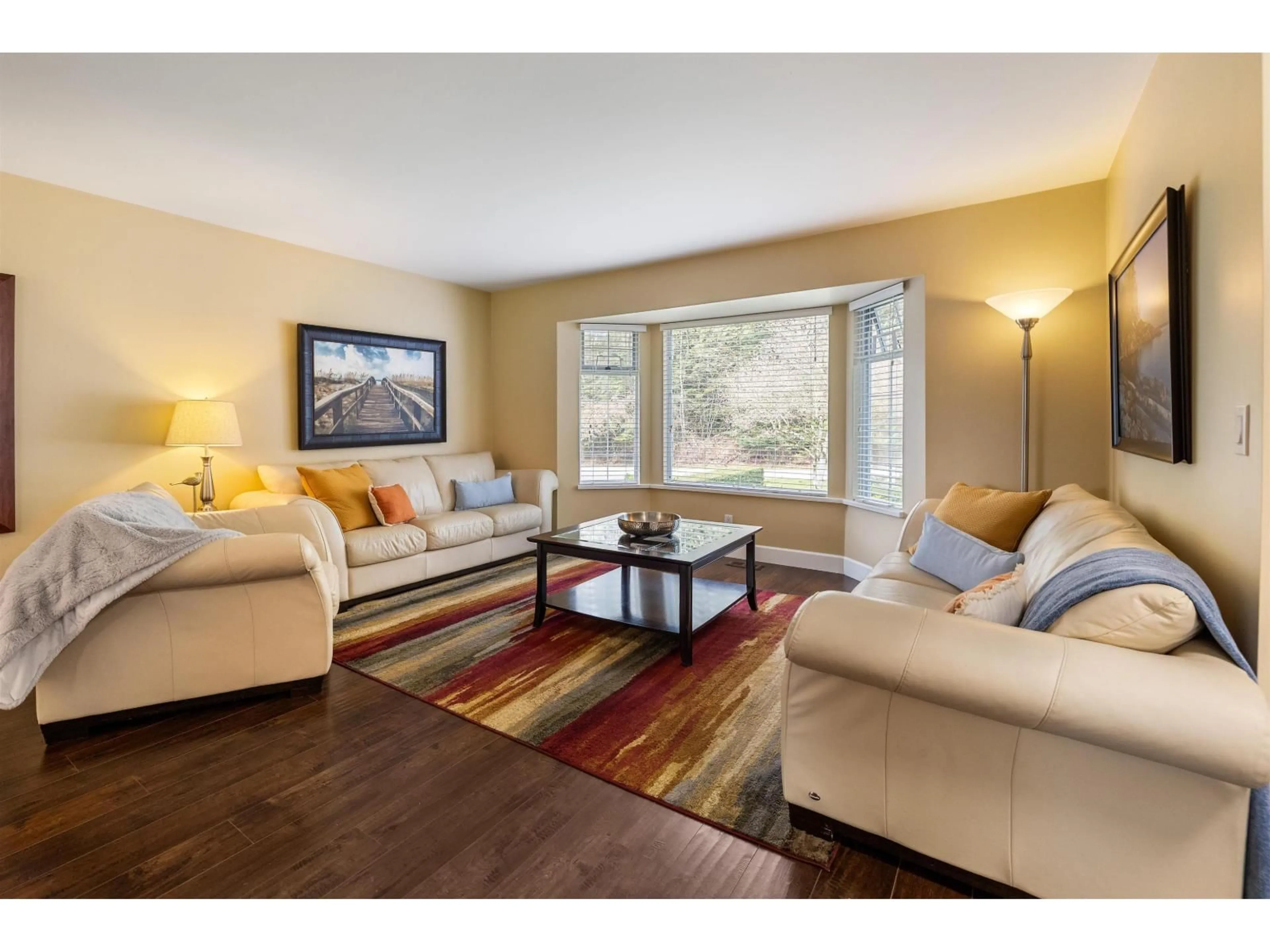 Living room with furniture, wood/laminate floor for 14316 92 AVENUE, Surrey British Columbia V3V1J6