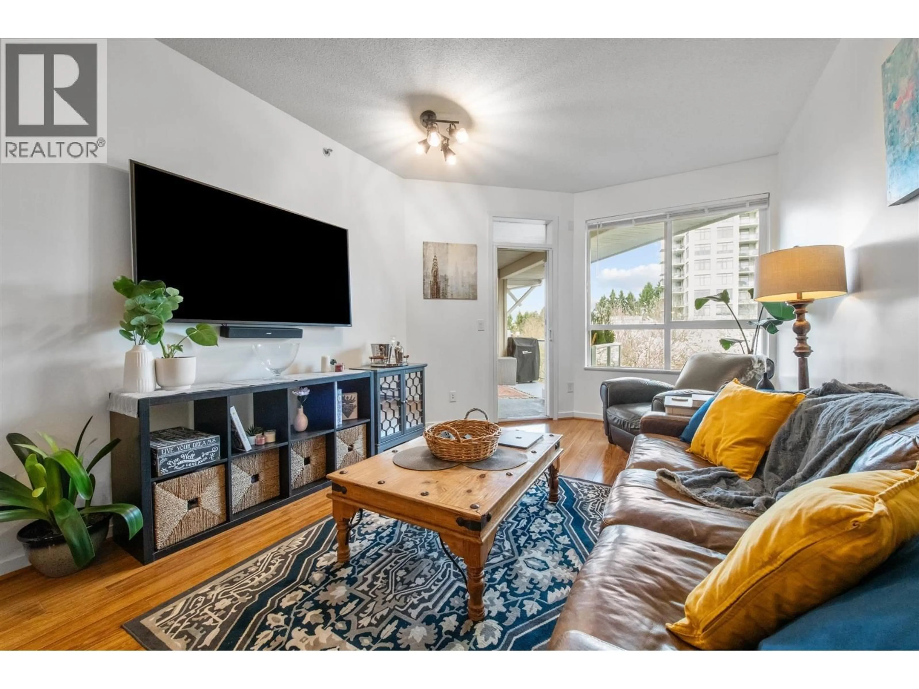 Living room with furniture, wood/laminate floor for 411 - 3551 FOSTER AVENUE, Vancouver British Columbia V5R0A1
