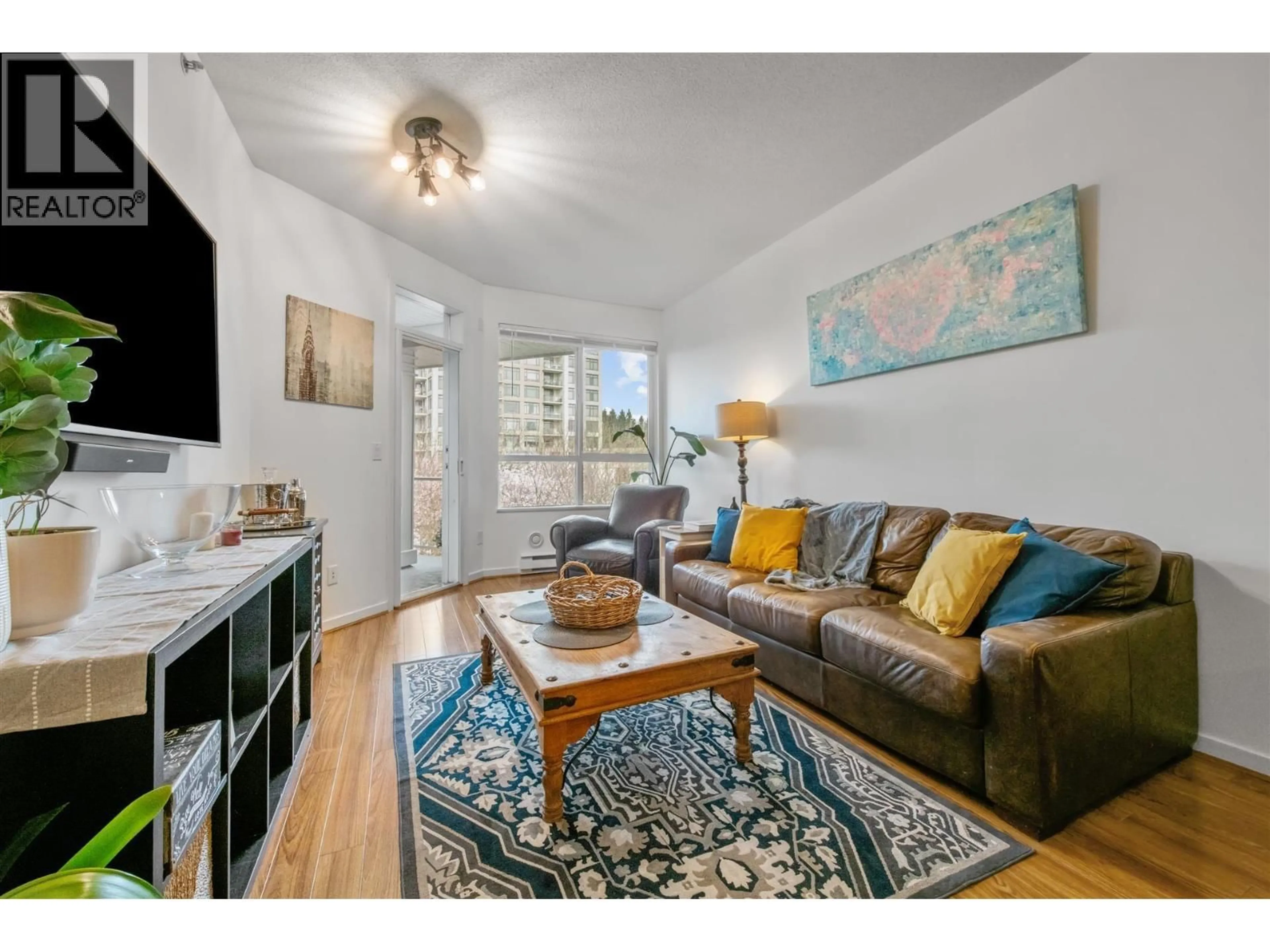 Living room with furniture, wood/laminate floor for 411 - 3551 FOSTER AVENUE, Vancouver British Columbia V5R0A1