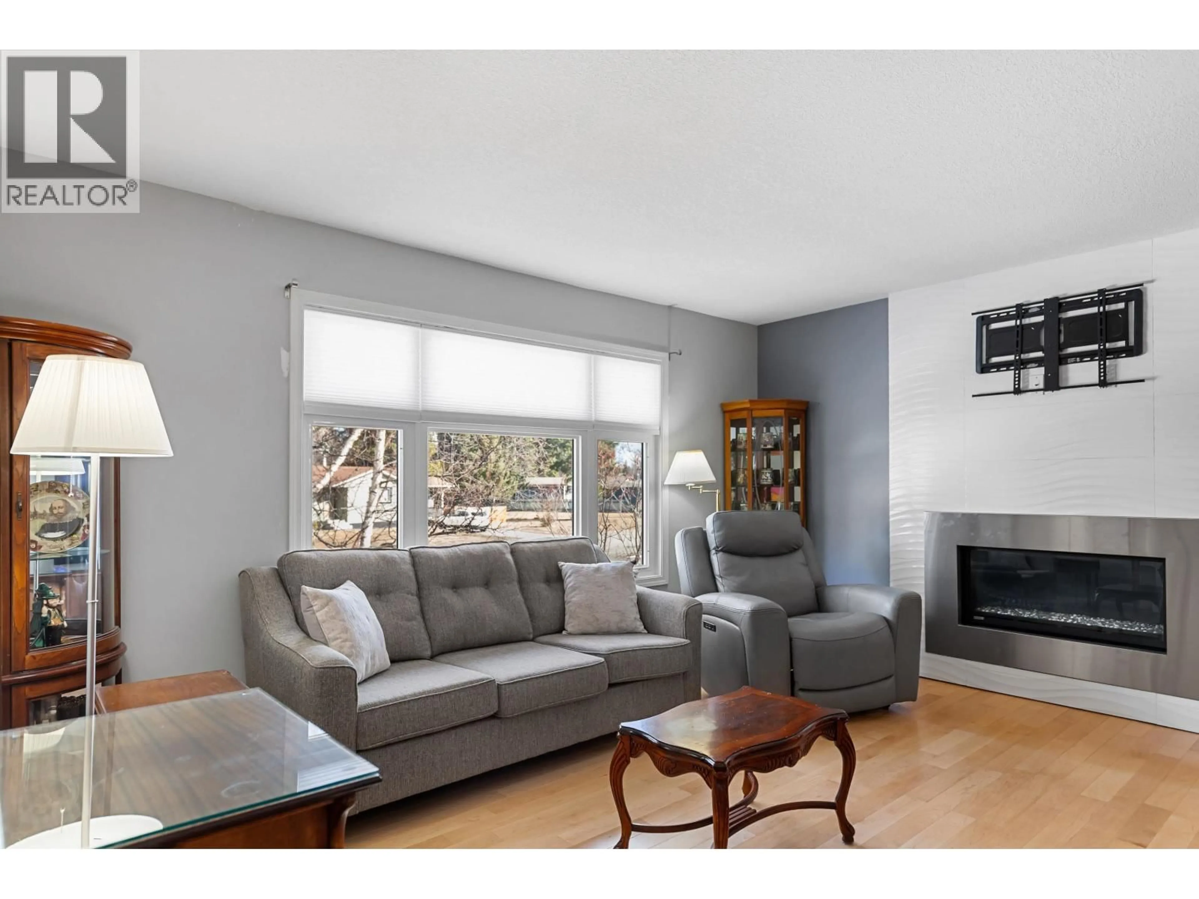 Living room with furniture, wood/laminate floor for 7837 PIEDMONT CRESCENT, Prince George British Columbia V2N3K8