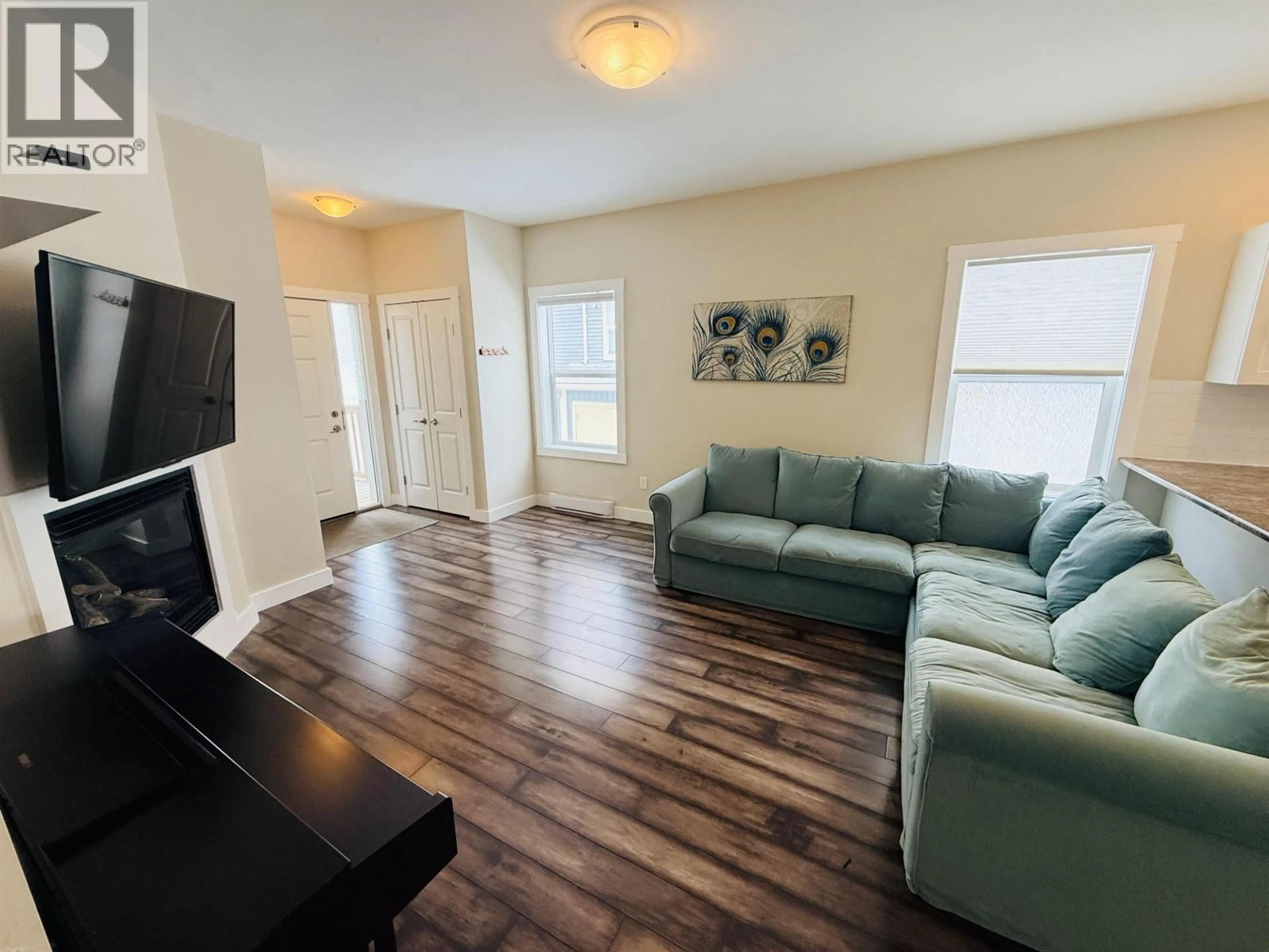 Living room with furniture, wood/laminate floor for 10217 112 STREET, Fort St. John British Columbia V1J0M2
