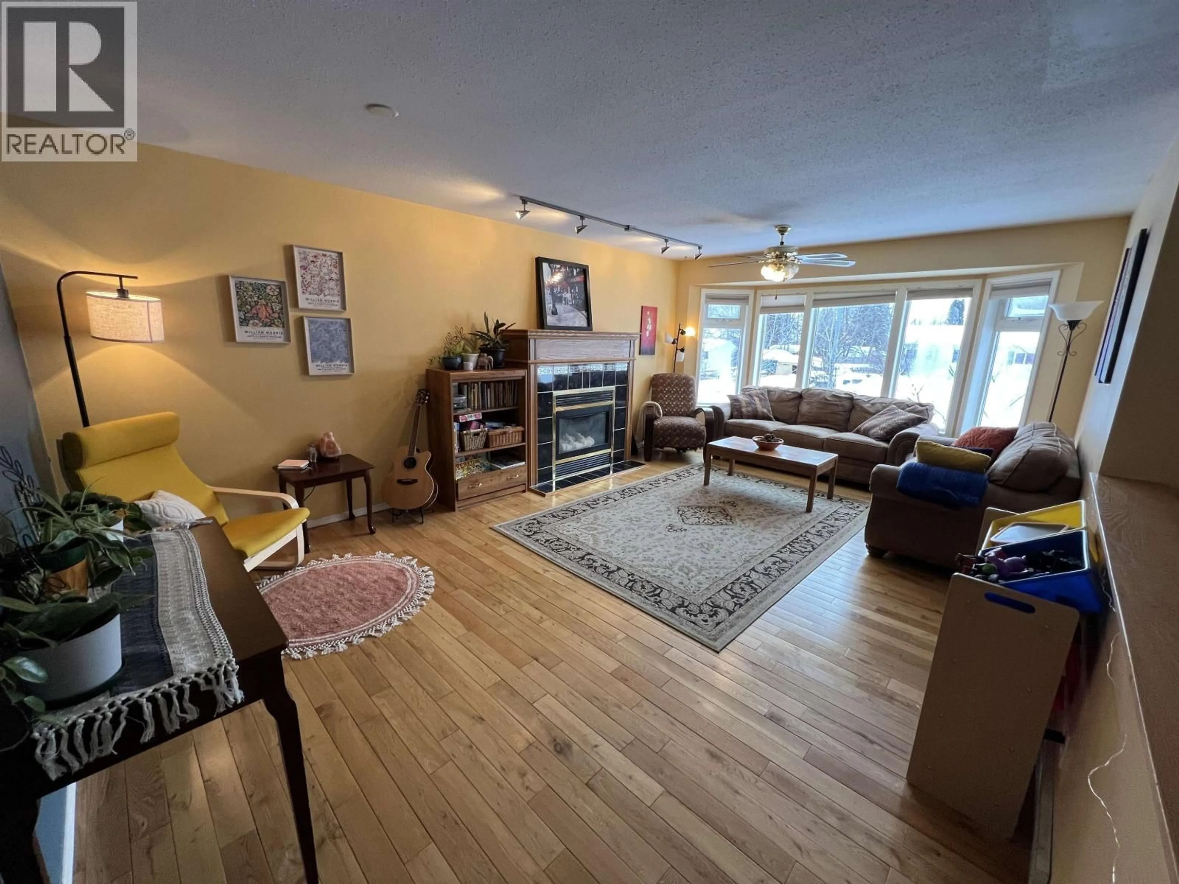 Living room with furniture, wood/laminate floor for 4824 GAIRDNER CRESCENT, Fort Nelson British Columbia V0C1R0