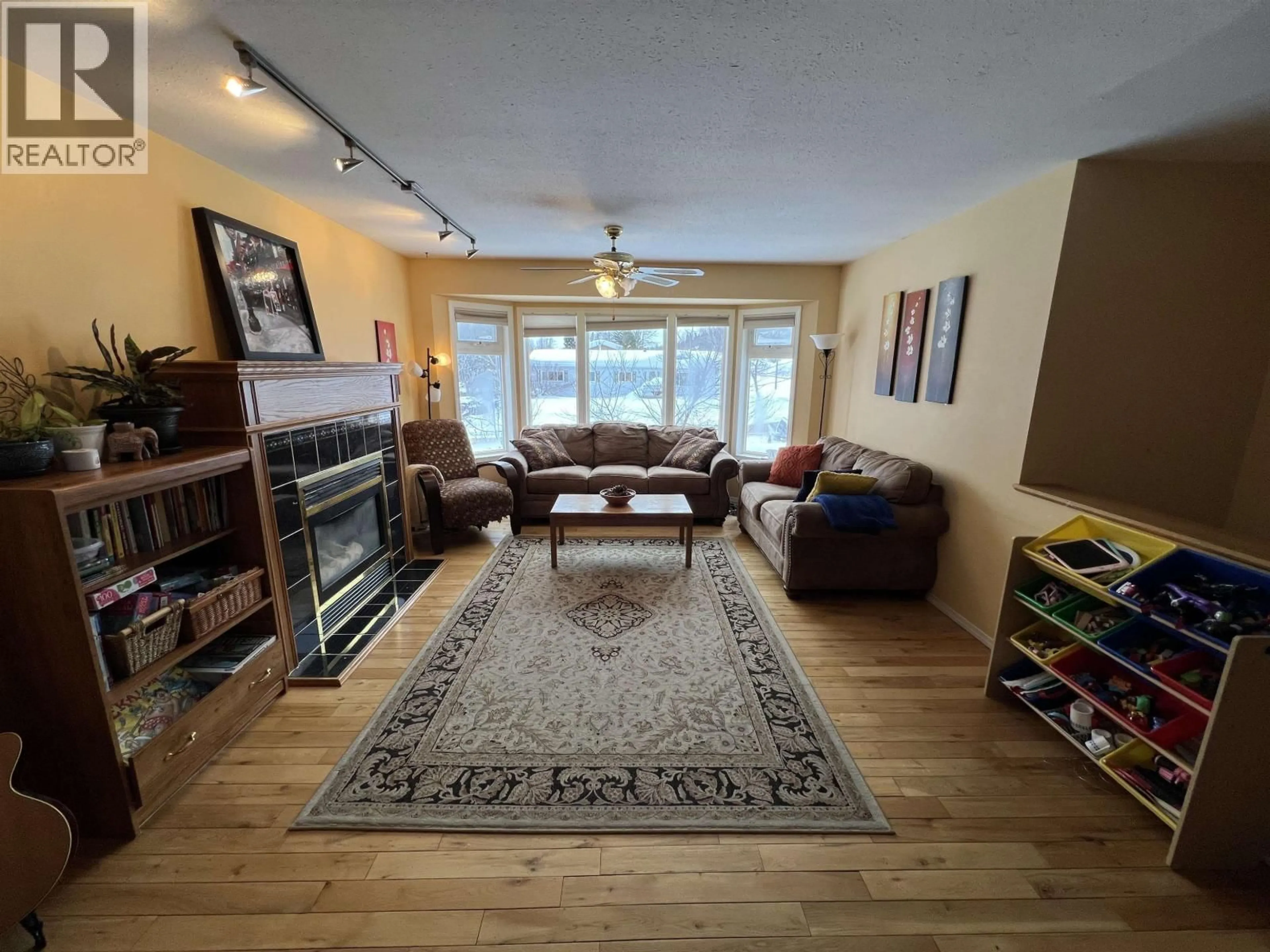 Living room with furniture, wood/laminate floor for 4824 GAIRDNER CRESCENT, Fort Nelson British Columbia V0C1R0