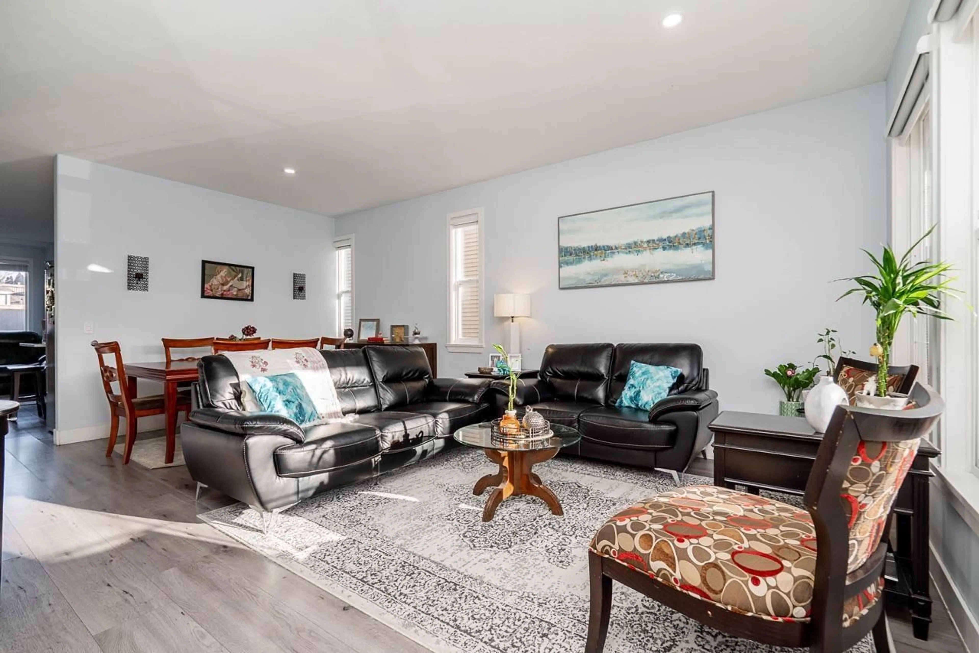 Living room with furniture, wood/laminate floor for 6926 190 STREET, Surrey British Columbia V4N5P1