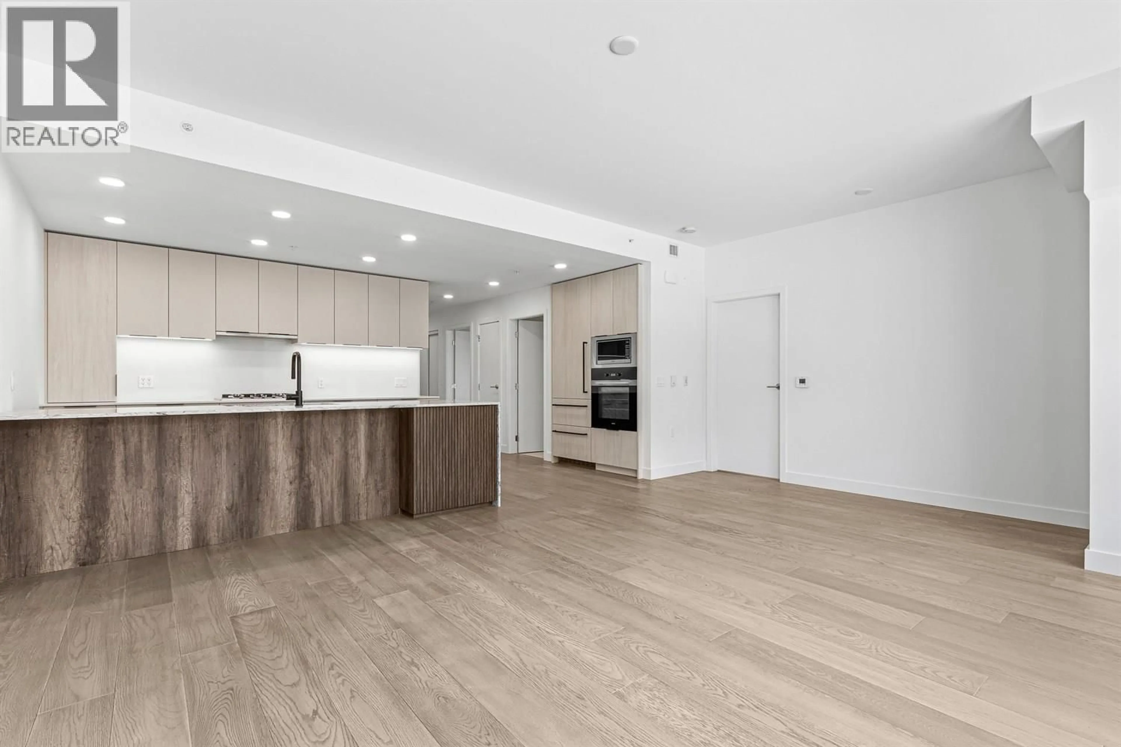 Open concept kitchen, wood/laminate floor for 204 - 3590 39TH AVENUE, Vancouver British Columbia V6N3A5