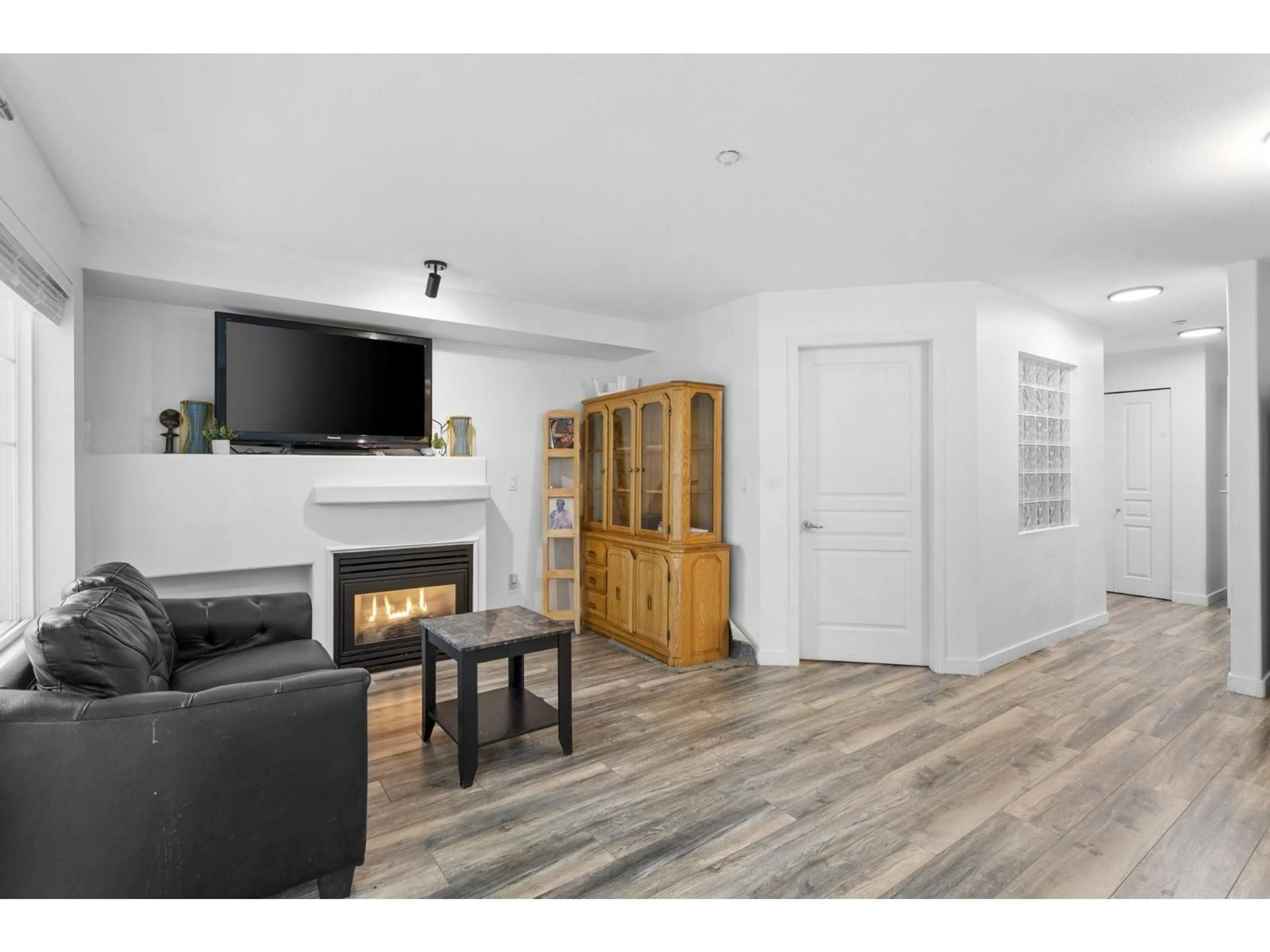 Living room with furniture, wood/laminate floor for 217 - 20200 56 AVENUE, Langley British Columbia V3A8S1
