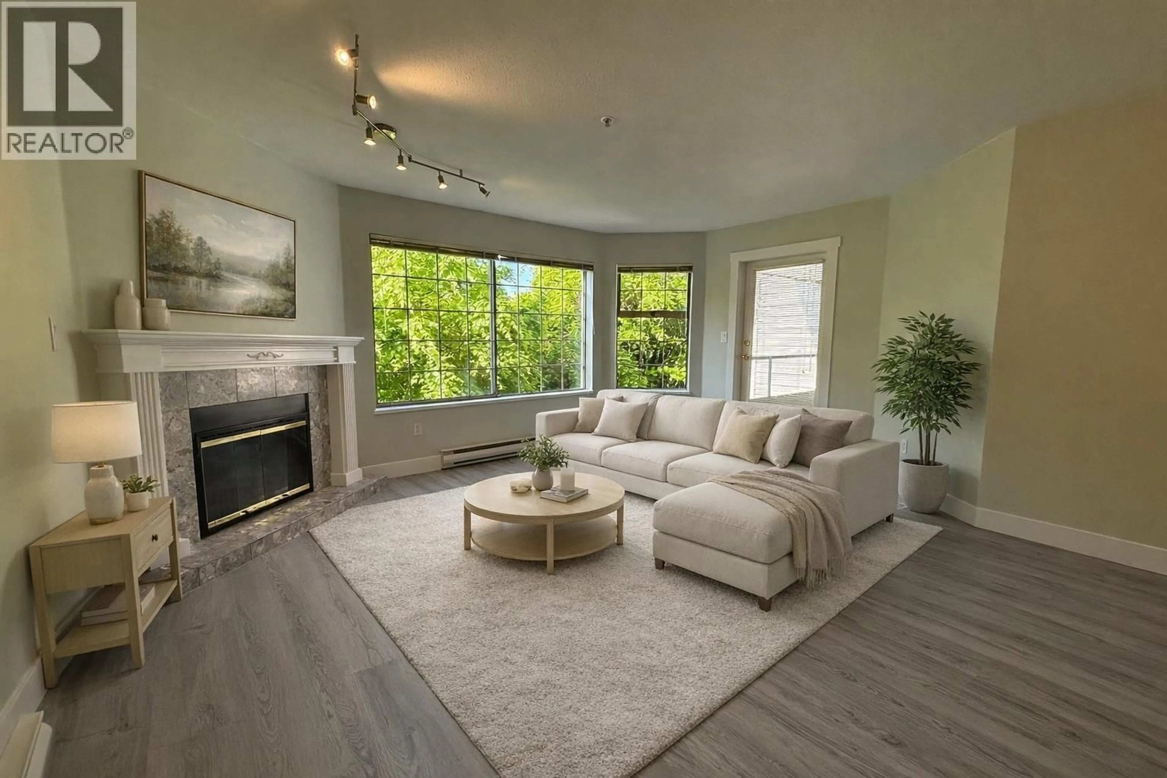 Living room with furniture, wood/laminate floor for 206 - 1955 SUFFOLK AVENUE, Port Coquitlam British Columbia V3B1H3