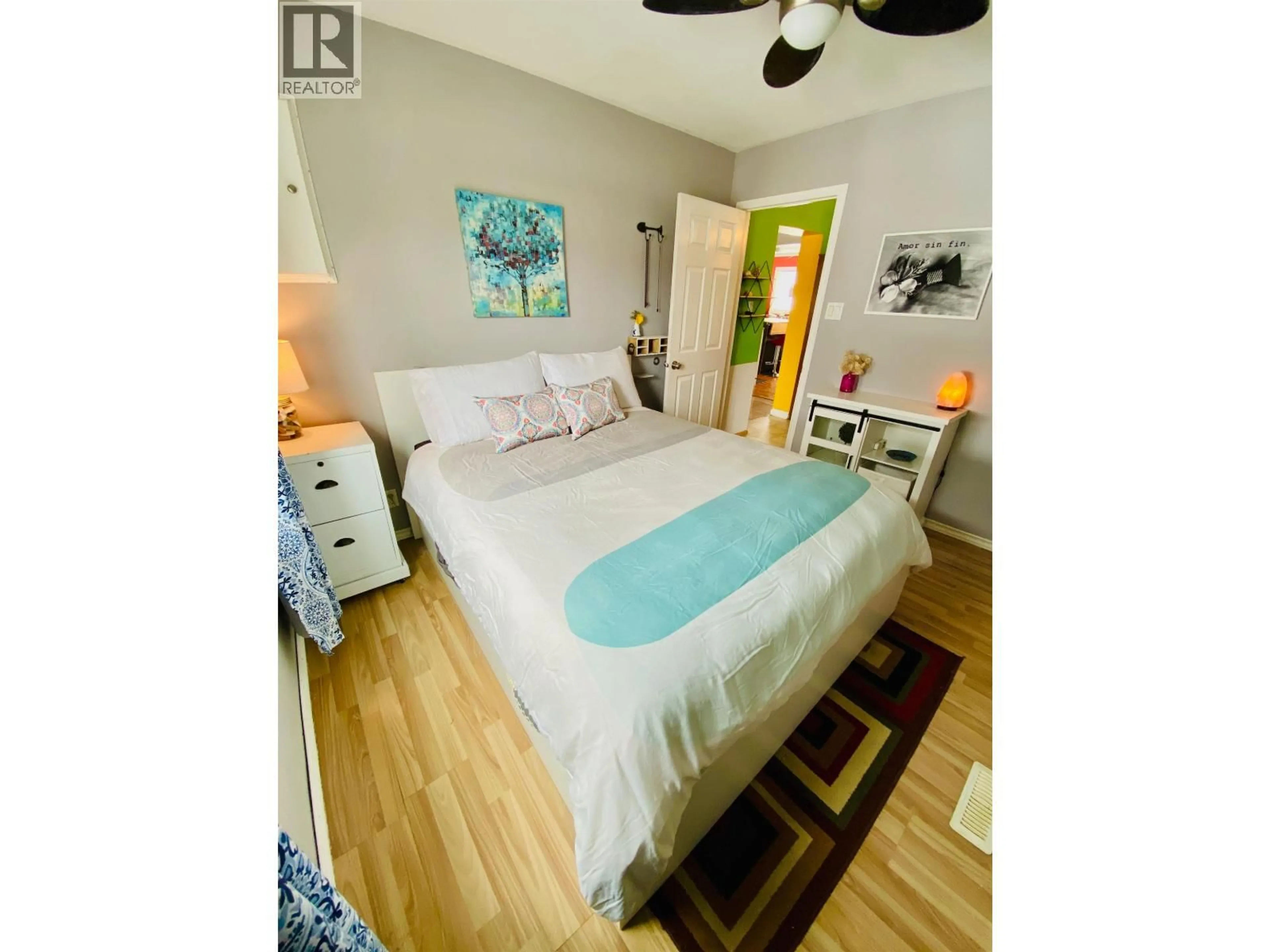Bedroom with bed, wood/laminate floor for 10647 101 STREET, Taylor British Columbia V0C2K0